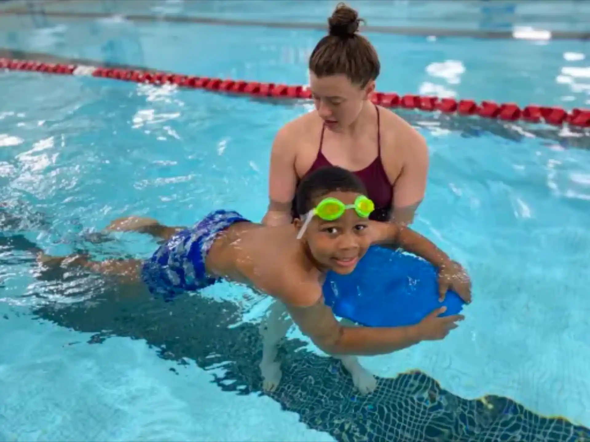 a person and a boy in a pool