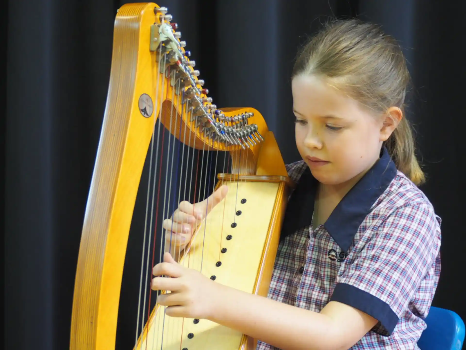 a young girl playing a cello