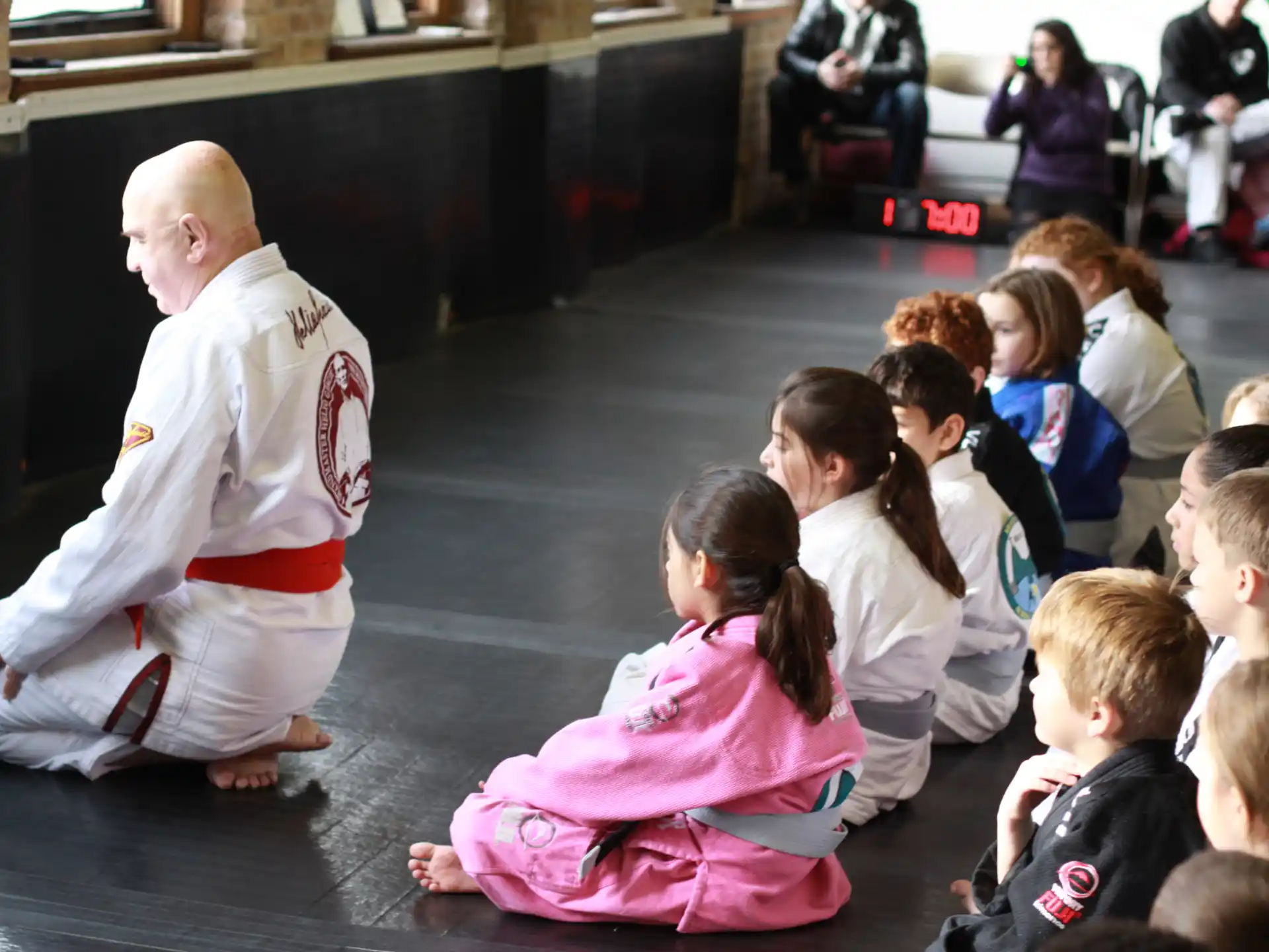 a person teaching children how to do martial arts