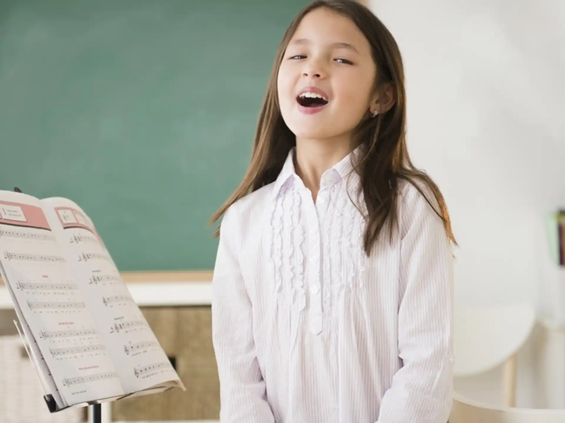 a girl holding a piece of paper