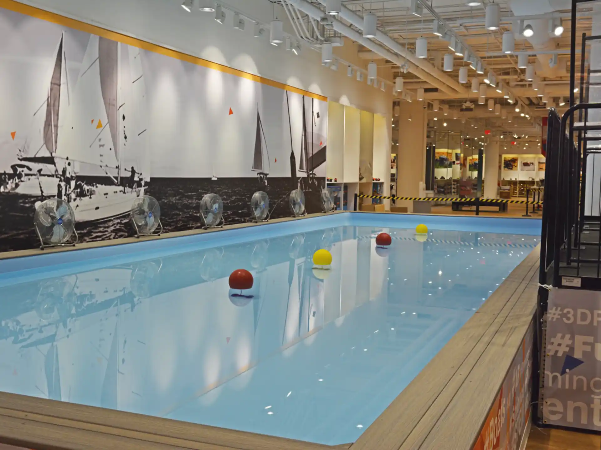 a pool with a model ship in the background