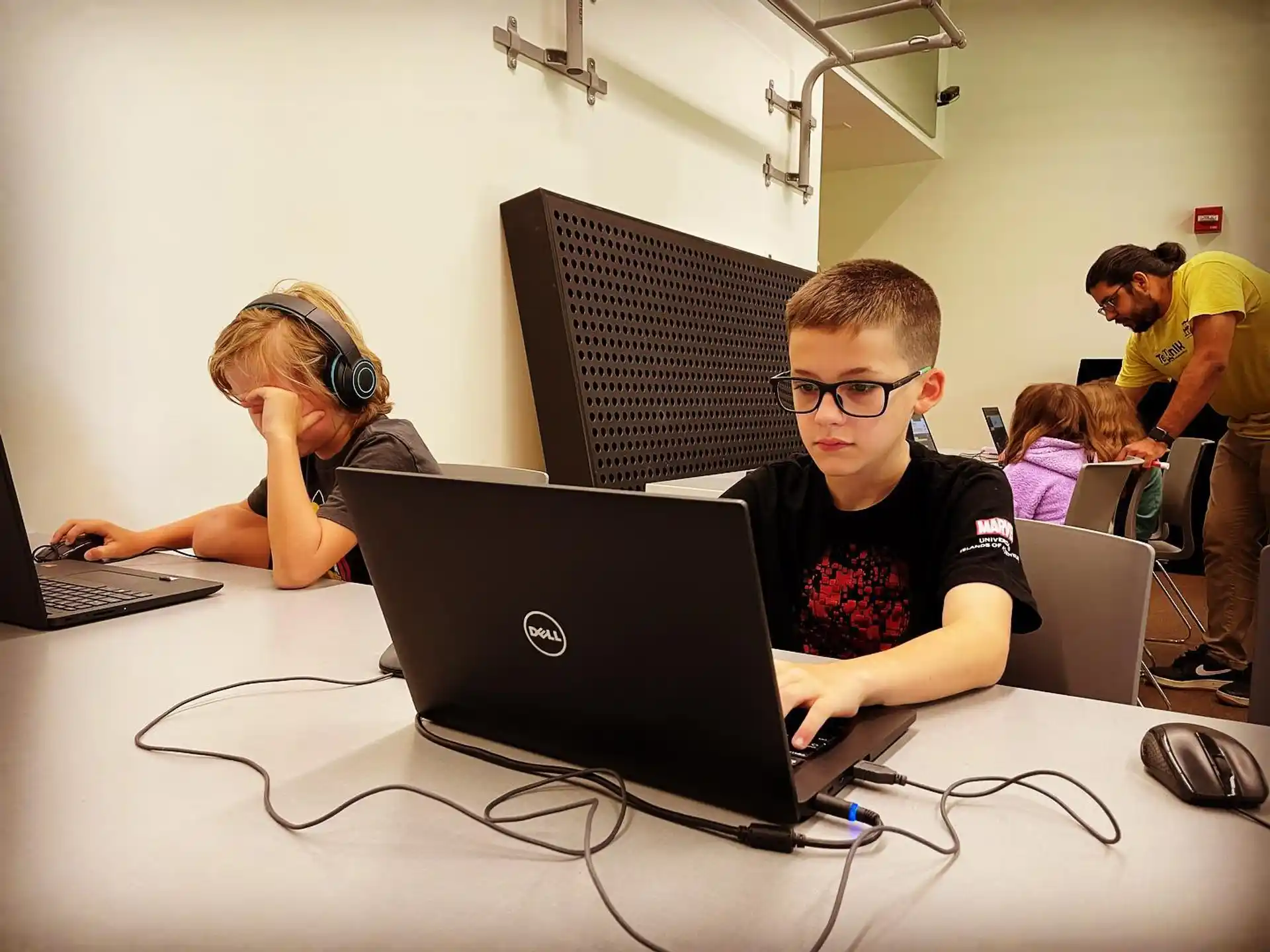 a group of people using laptops