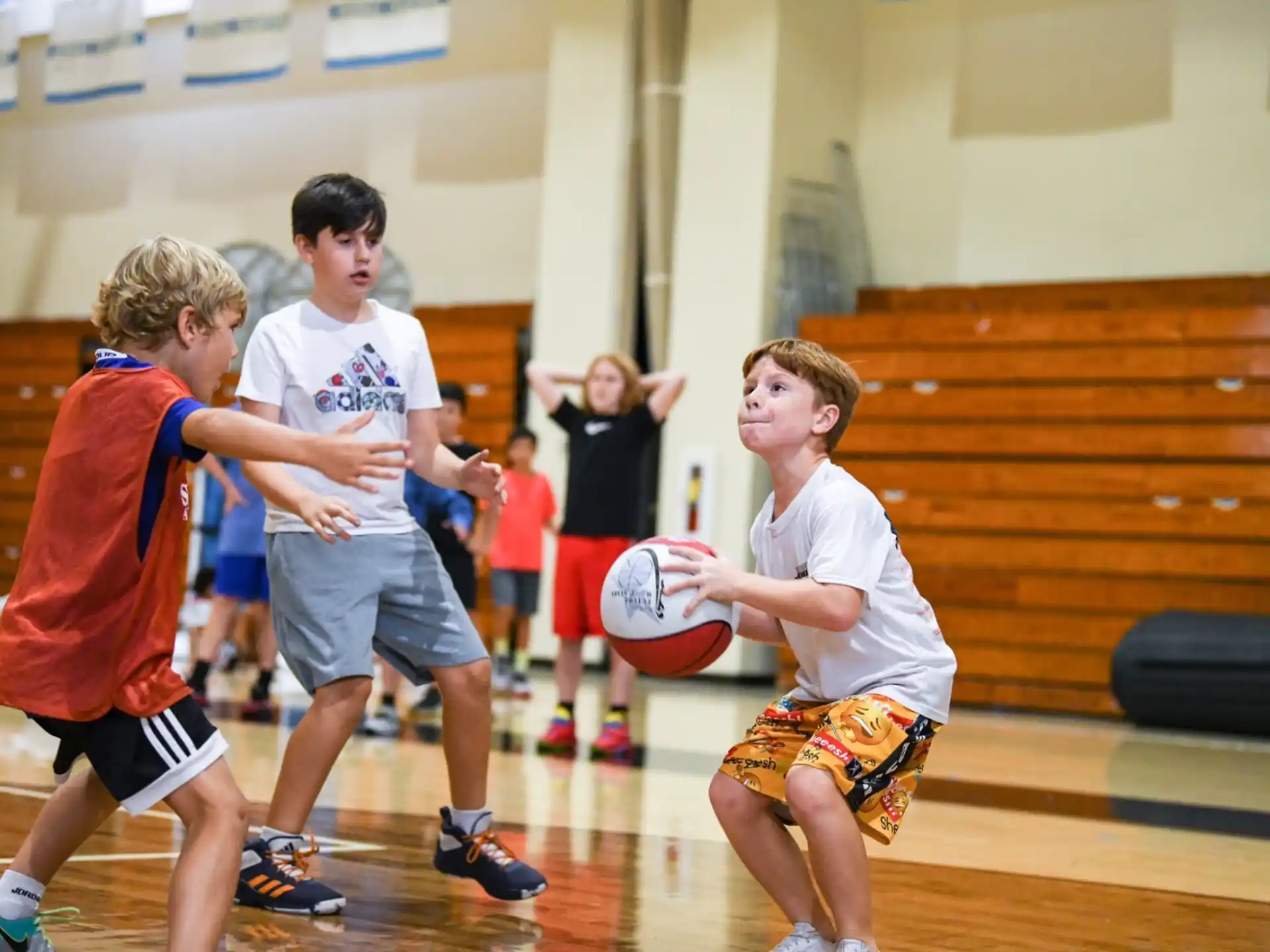 a group of kids playing basketball
