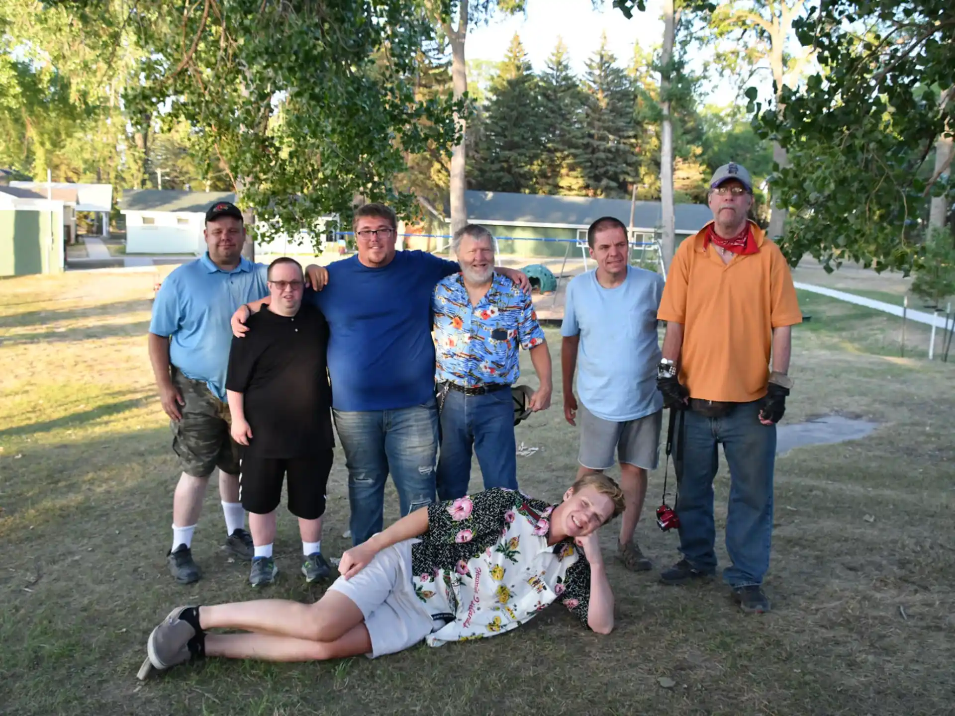 a group of men standing around a man lying on the ground