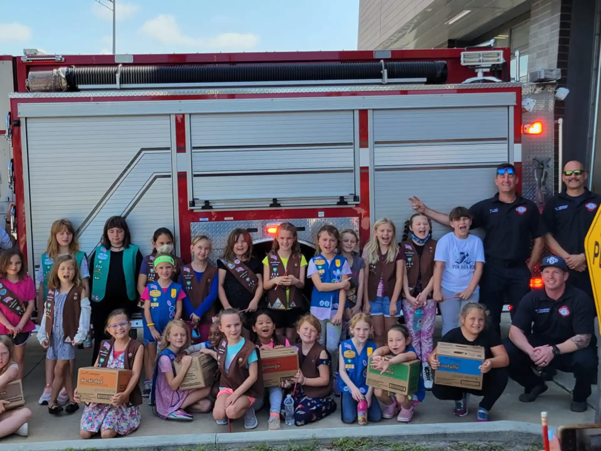 a group of people posing for a photo in front of a fire truck