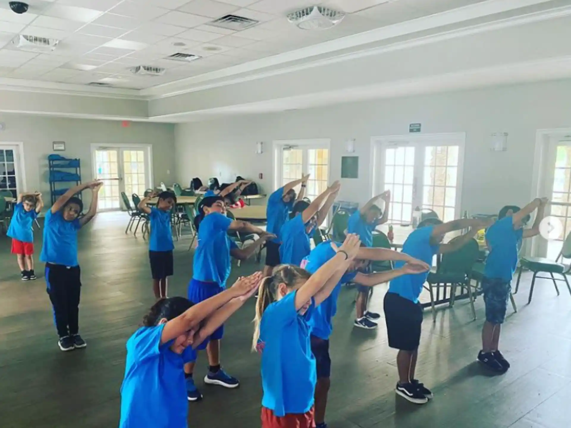 a group of people in blue shirts