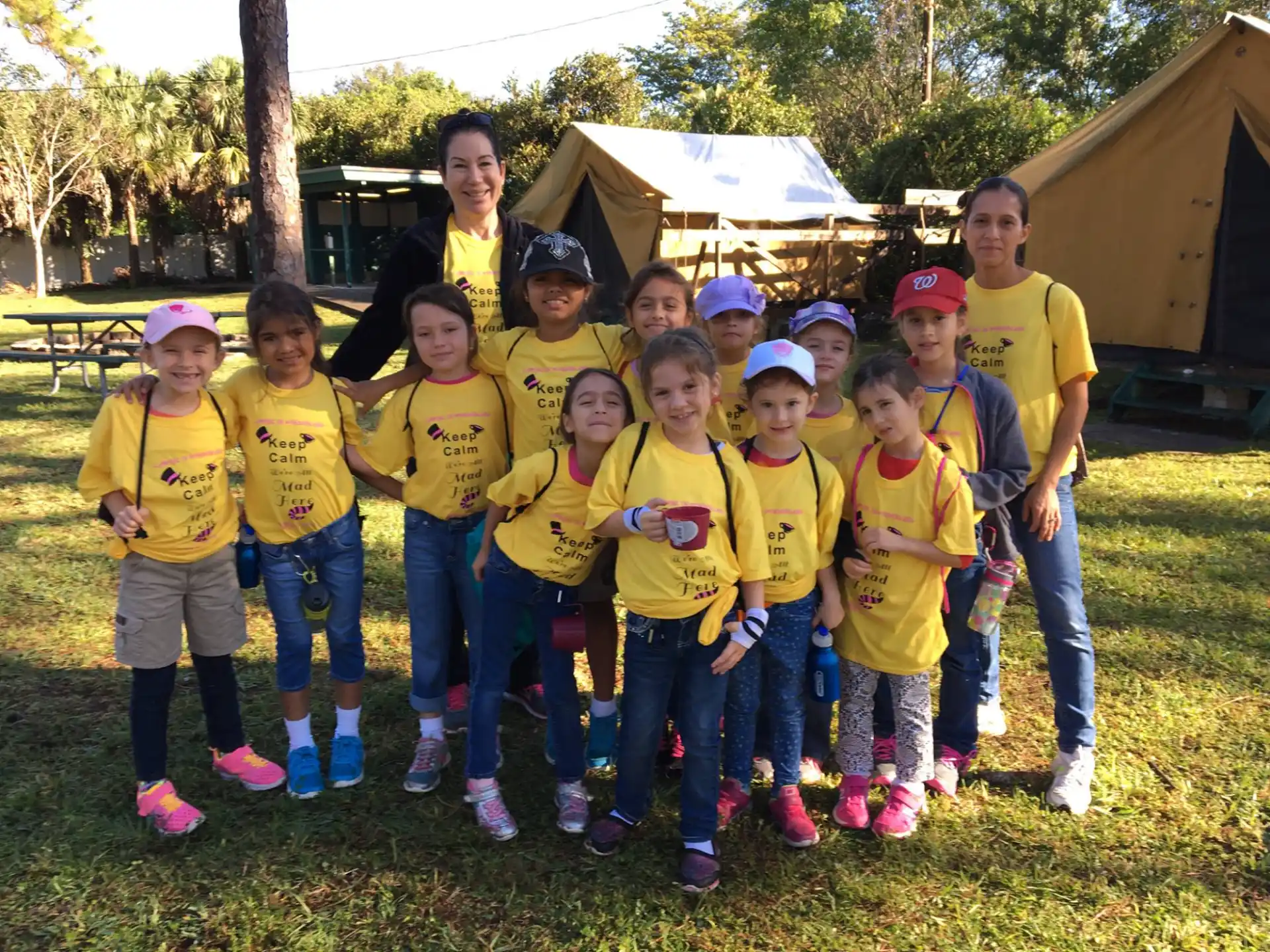 a group of children in matching yellow t-shirts