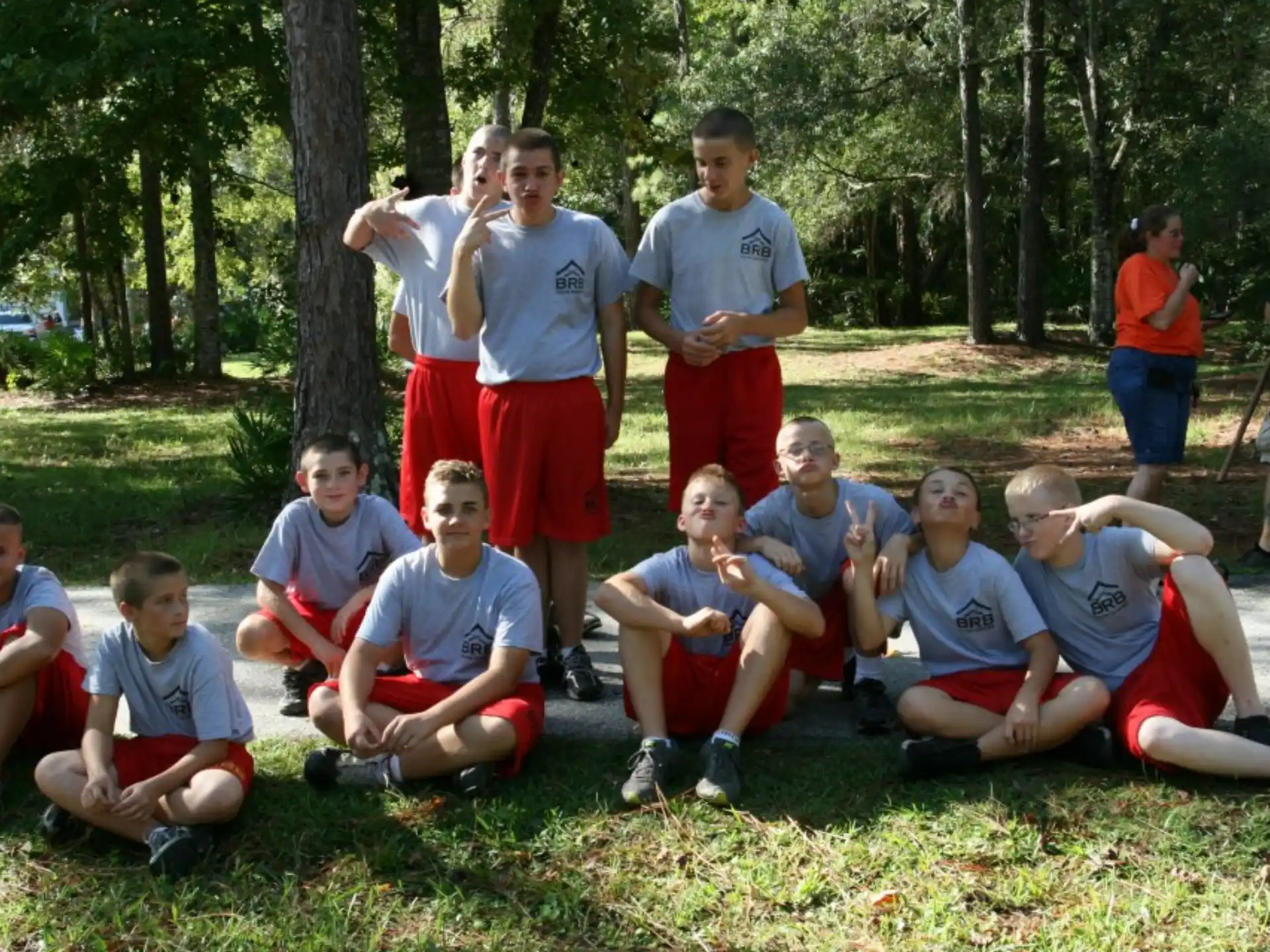 a group of people sitting on the grass