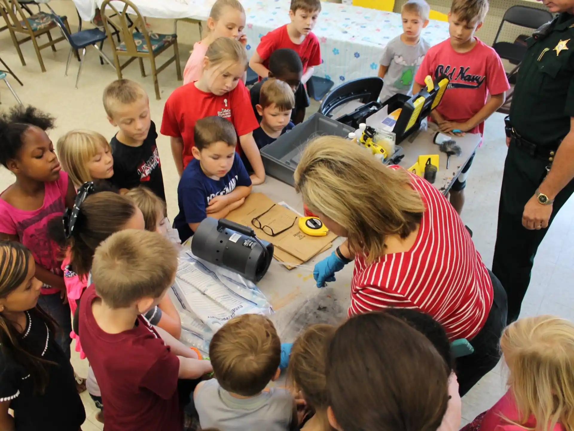 a group of children sitting around a table