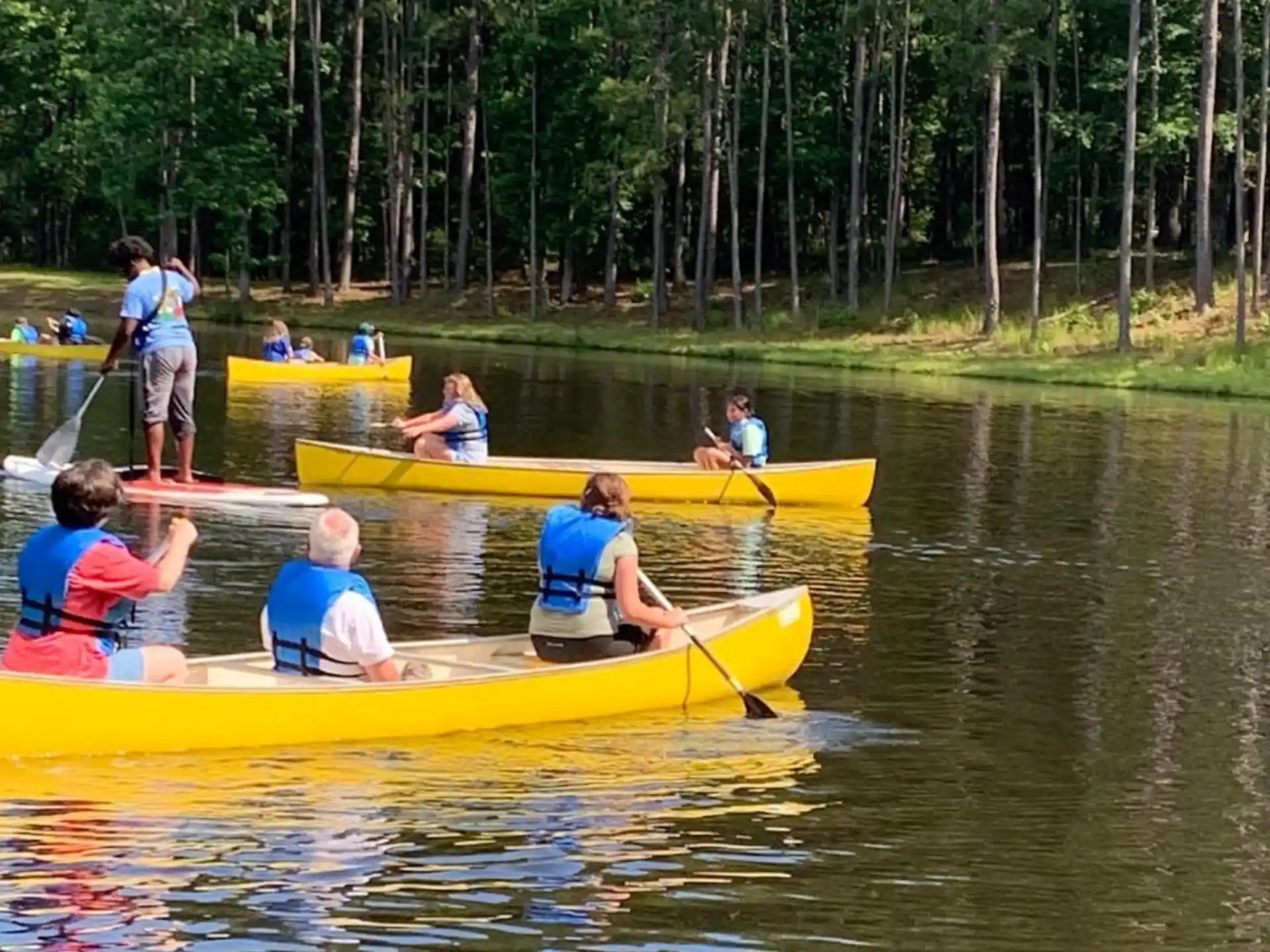 a group of people in canoes on a river