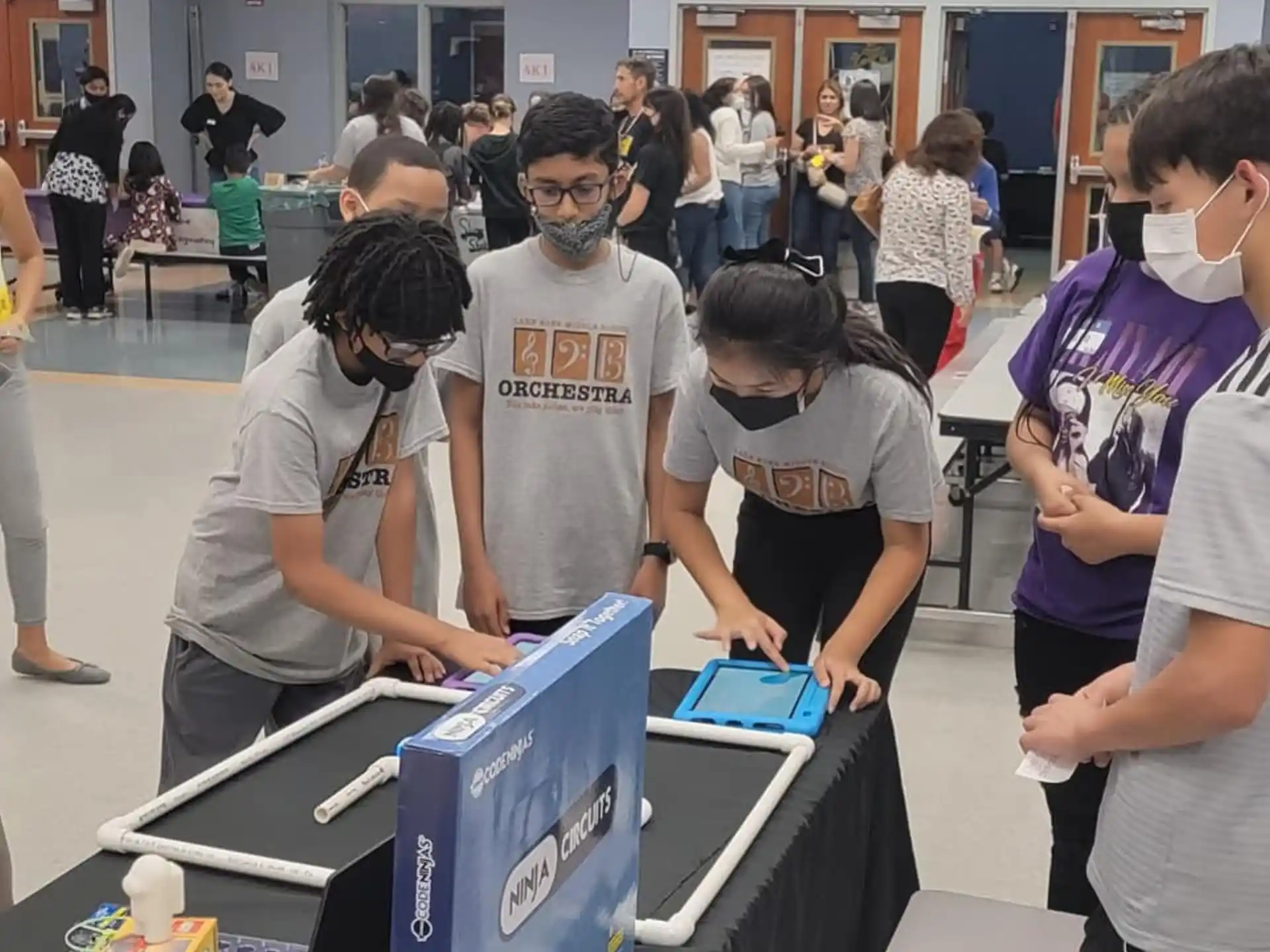 a group of people looking at a blue box