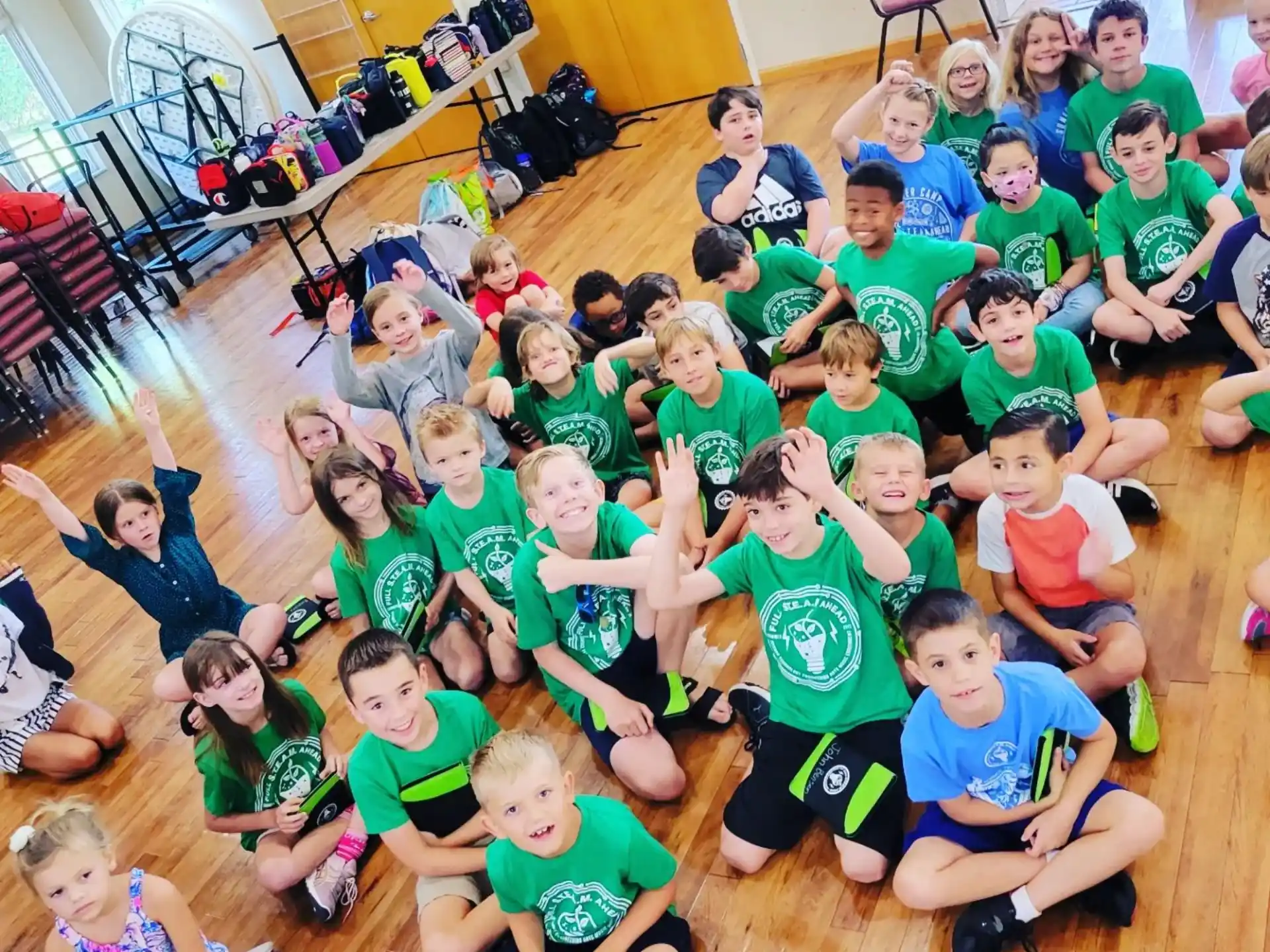 a group of children sitting on the floor in a room