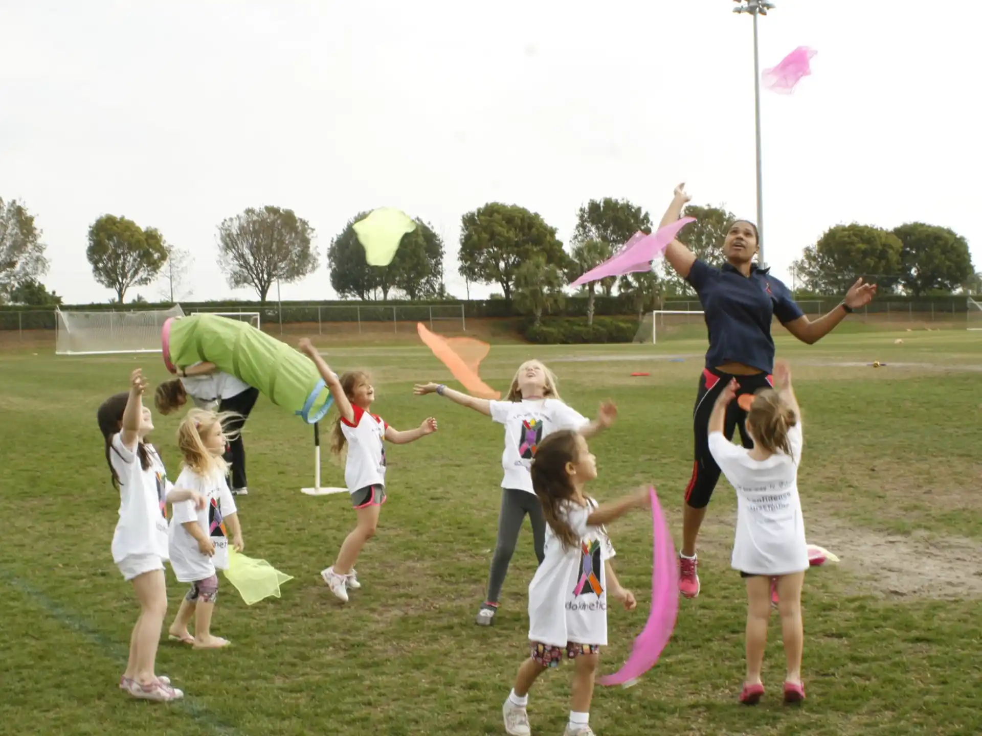 a group of people holding up a large pink and white object