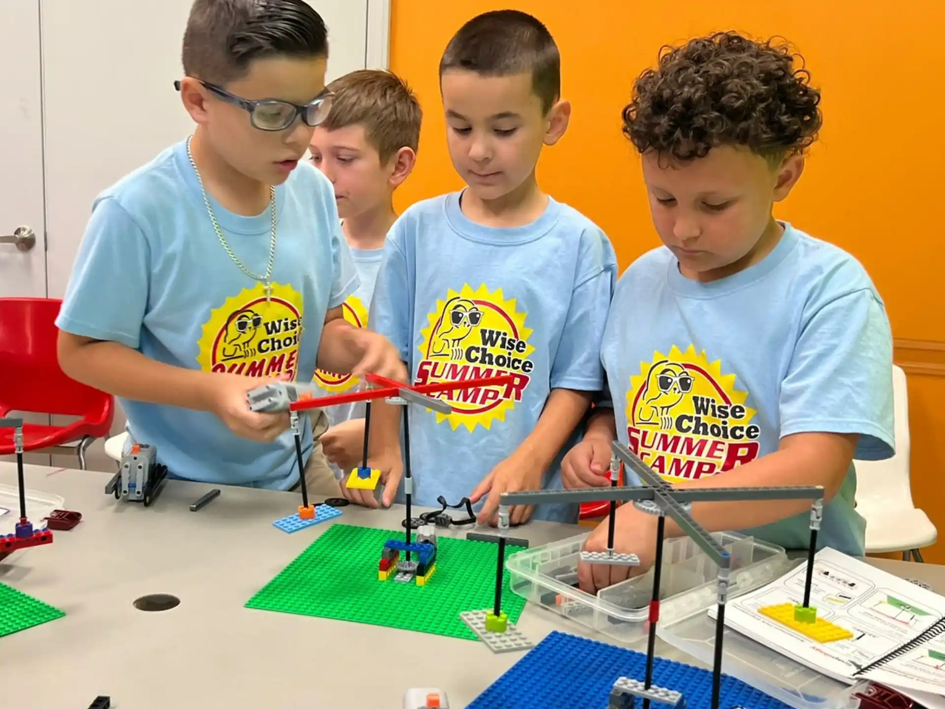 a group of boys looking at a model train
