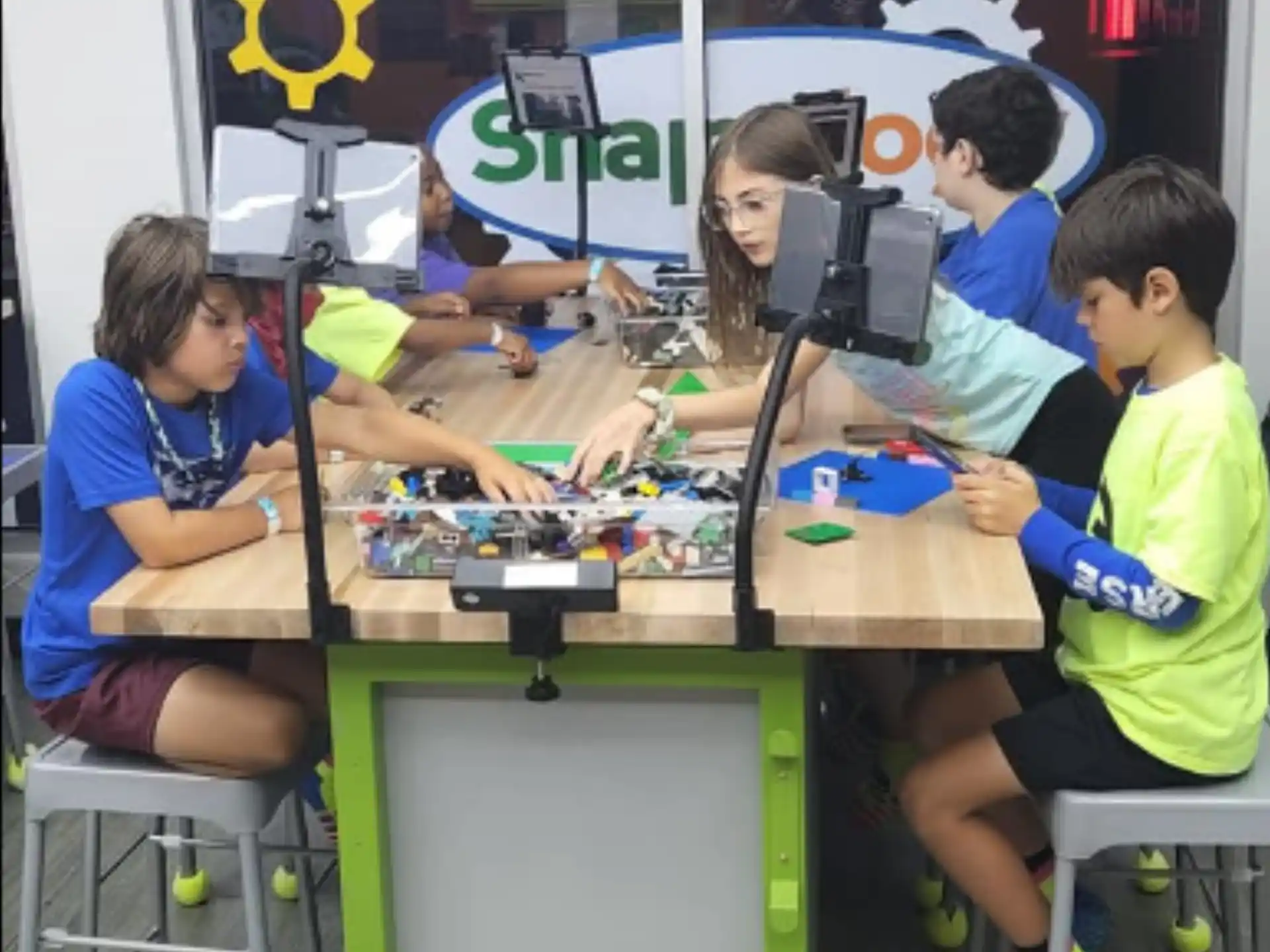a group of people sitting at a table with a camera