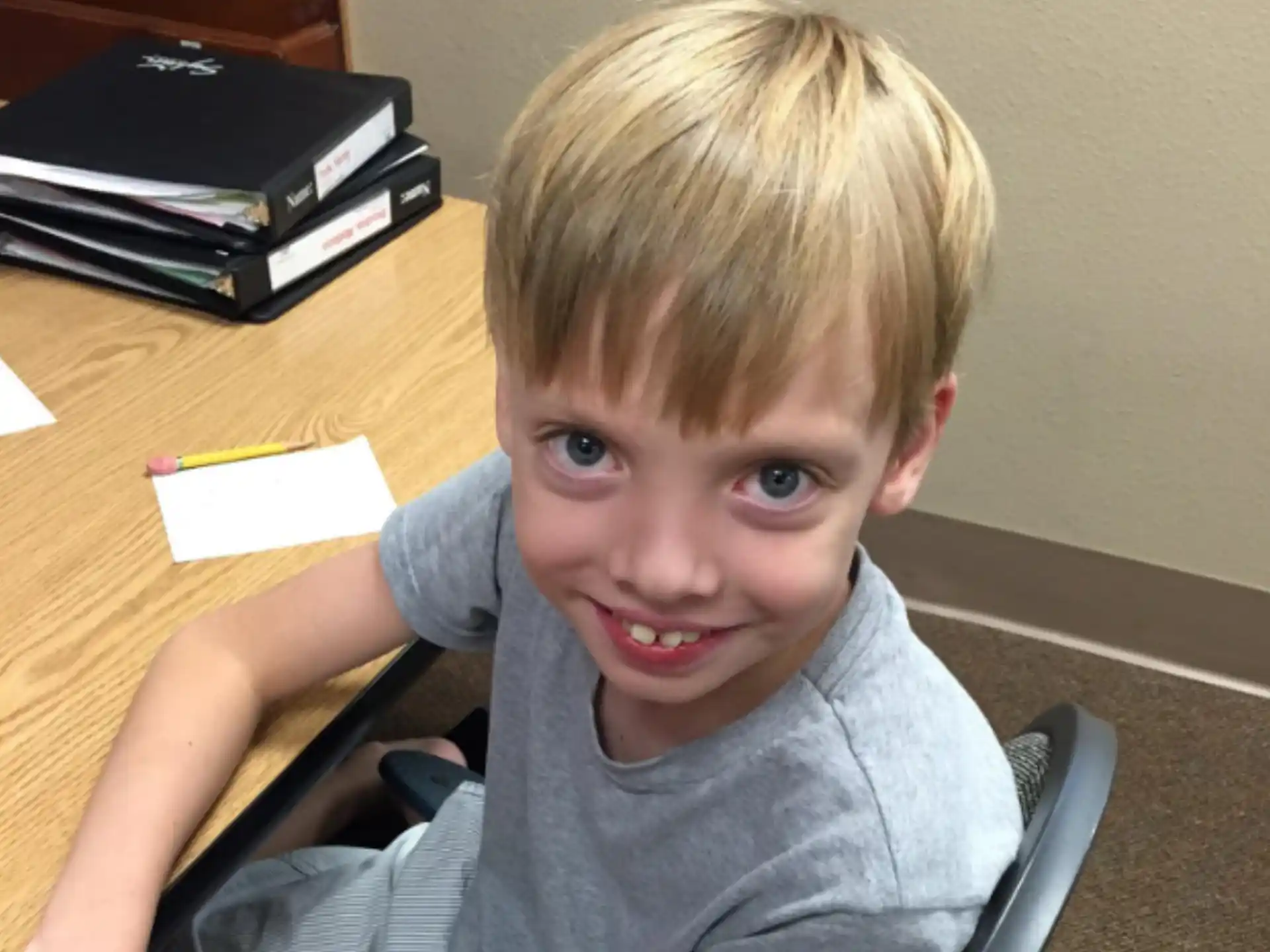 a boy sitting at a table