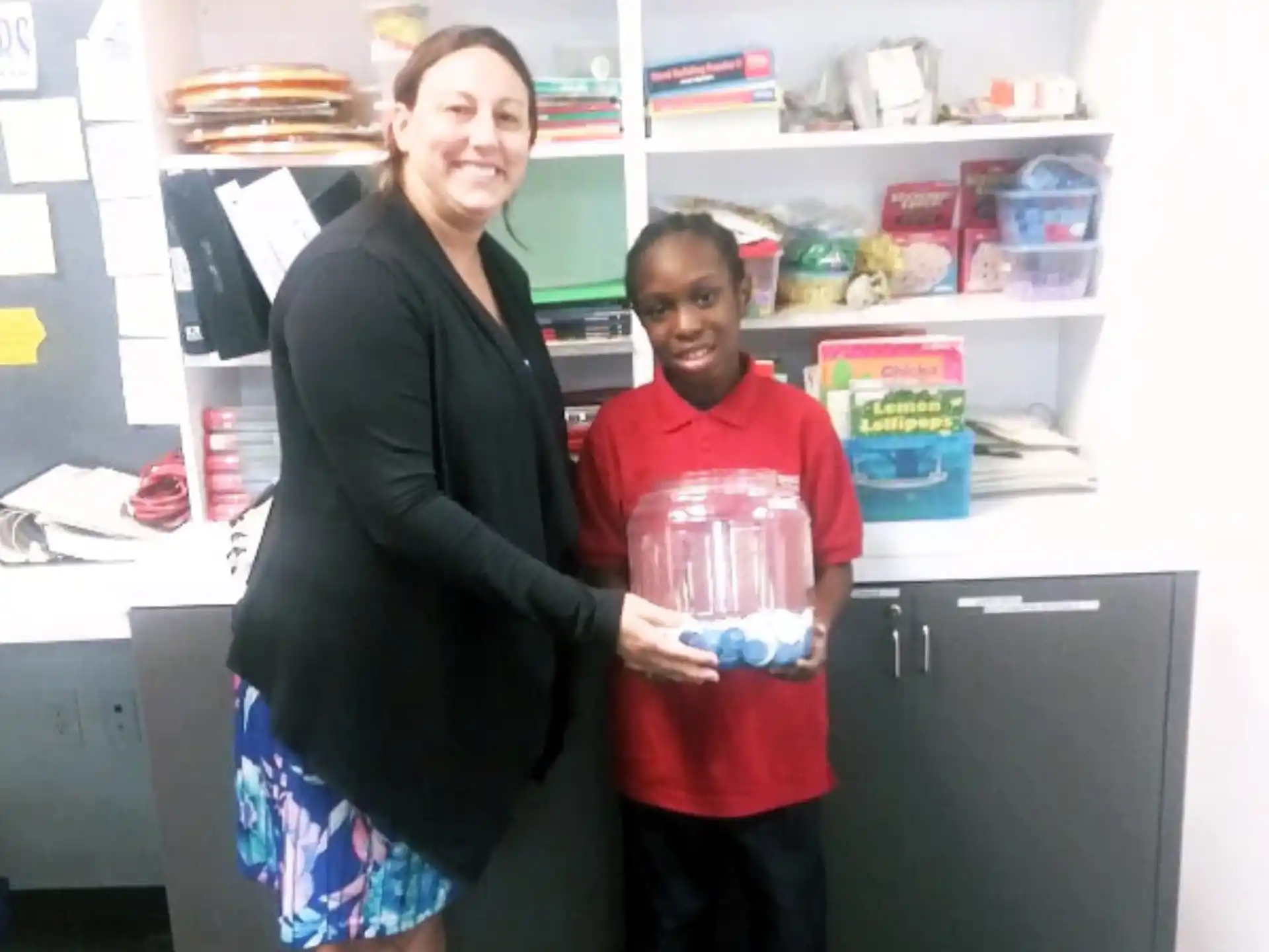 a person and a girl holding a box of cookies