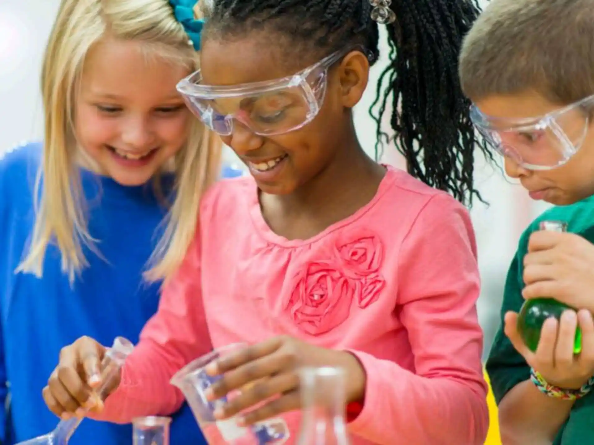 a group of children looking at a plastic bottle