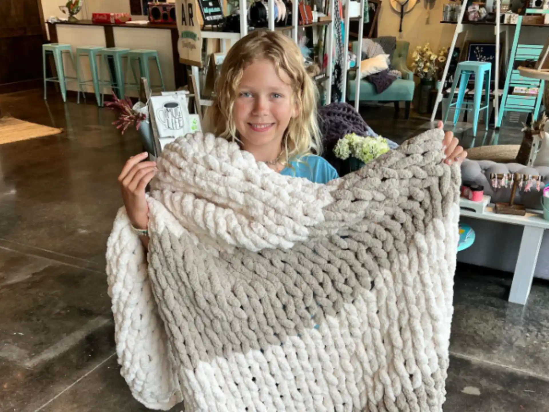a girl holding a large furry object