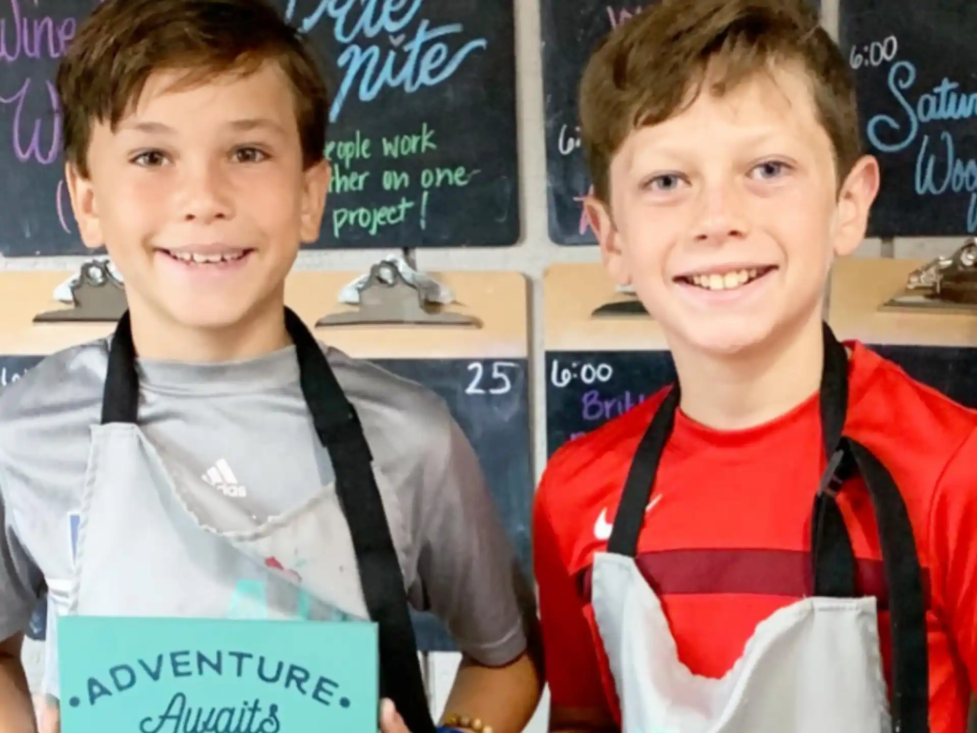 a couple of boys holding a sign