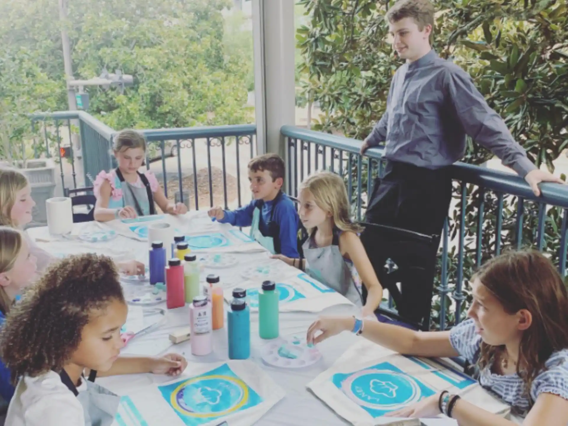 a group of children sitting around a table