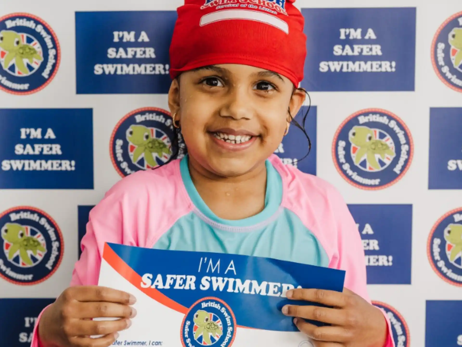 a person smiling with a medal around the neck