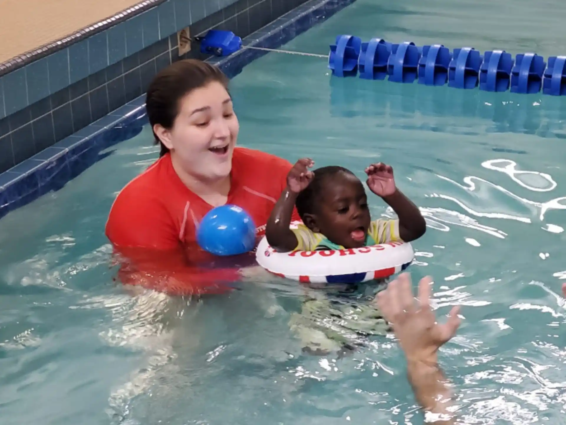 a person and a baby in a pool