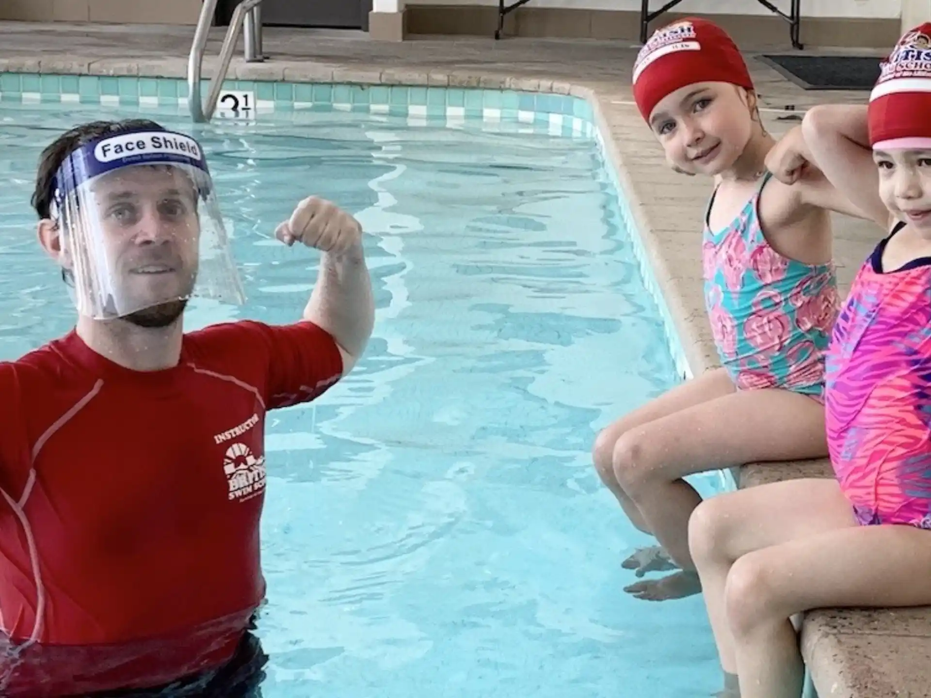 a person and two women in a pool