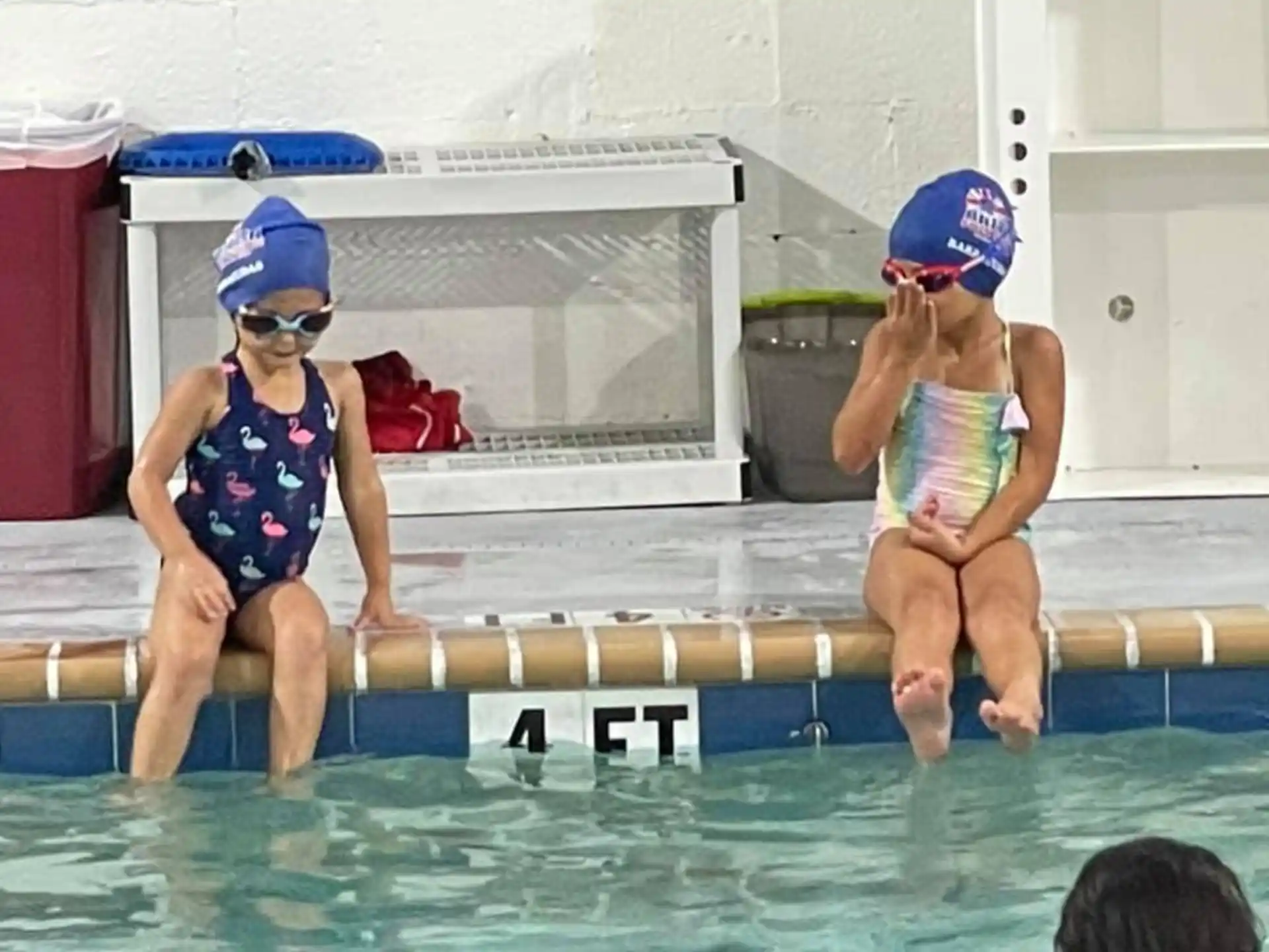 a couple of kids in a pool