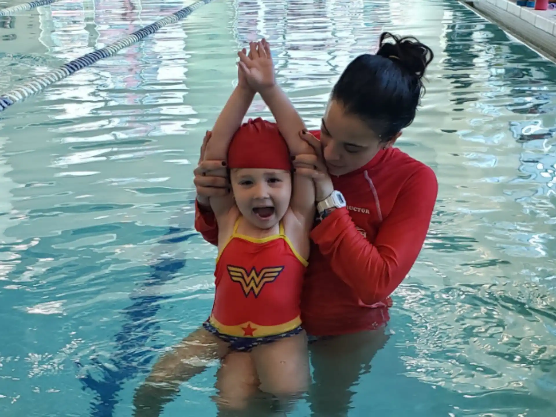 a person and a child in a pool