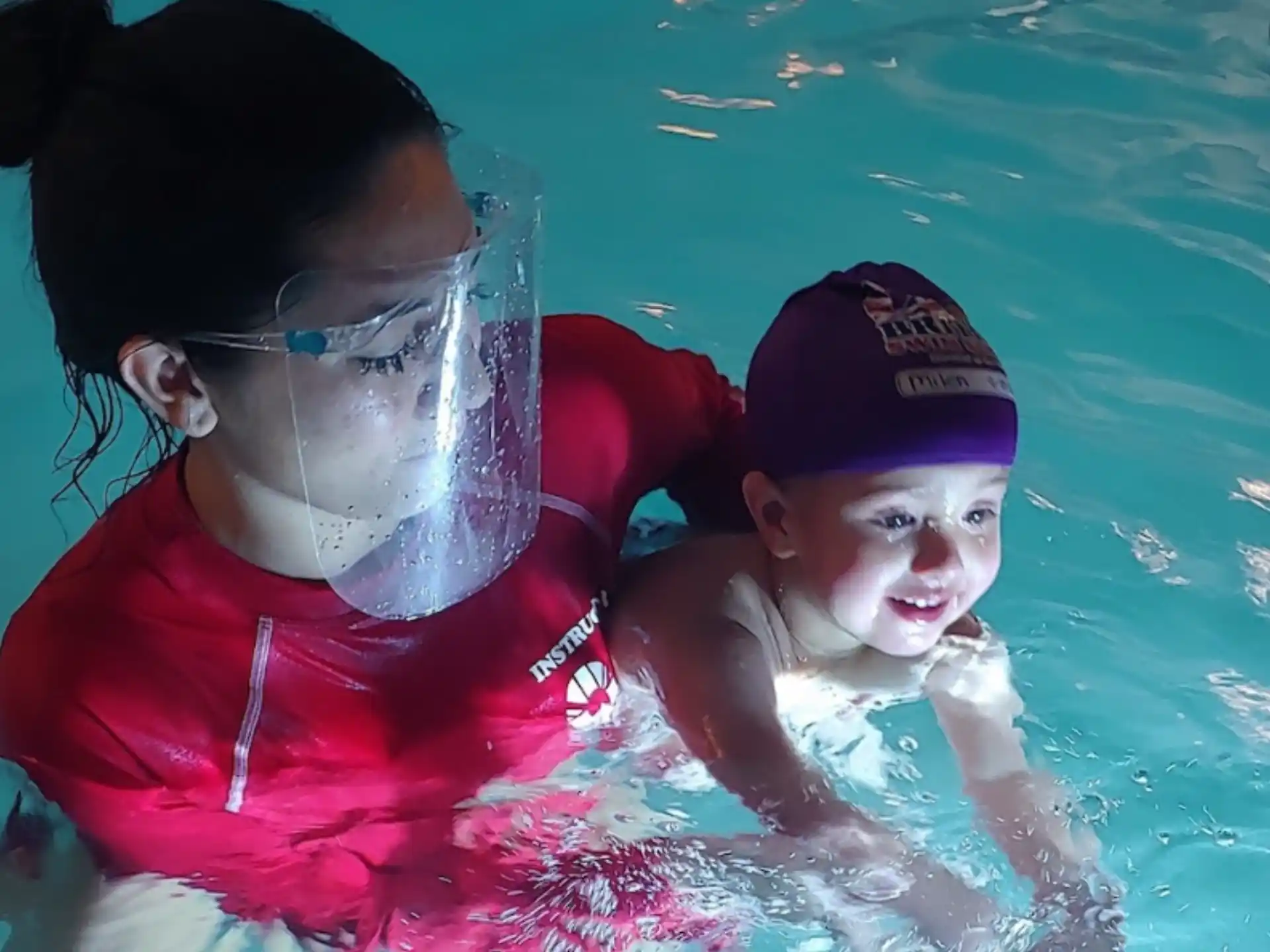 a person and a baby in a pool