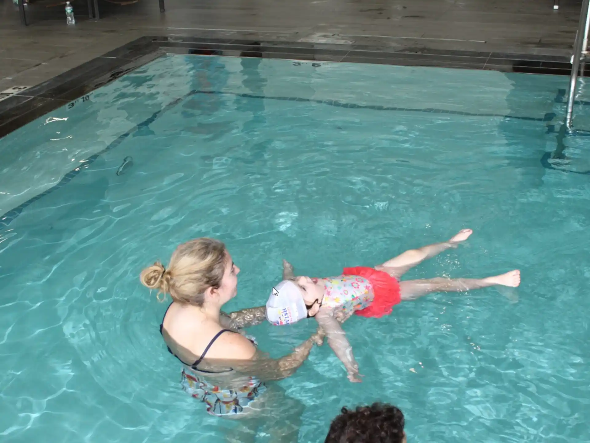 a person and a child in a pool