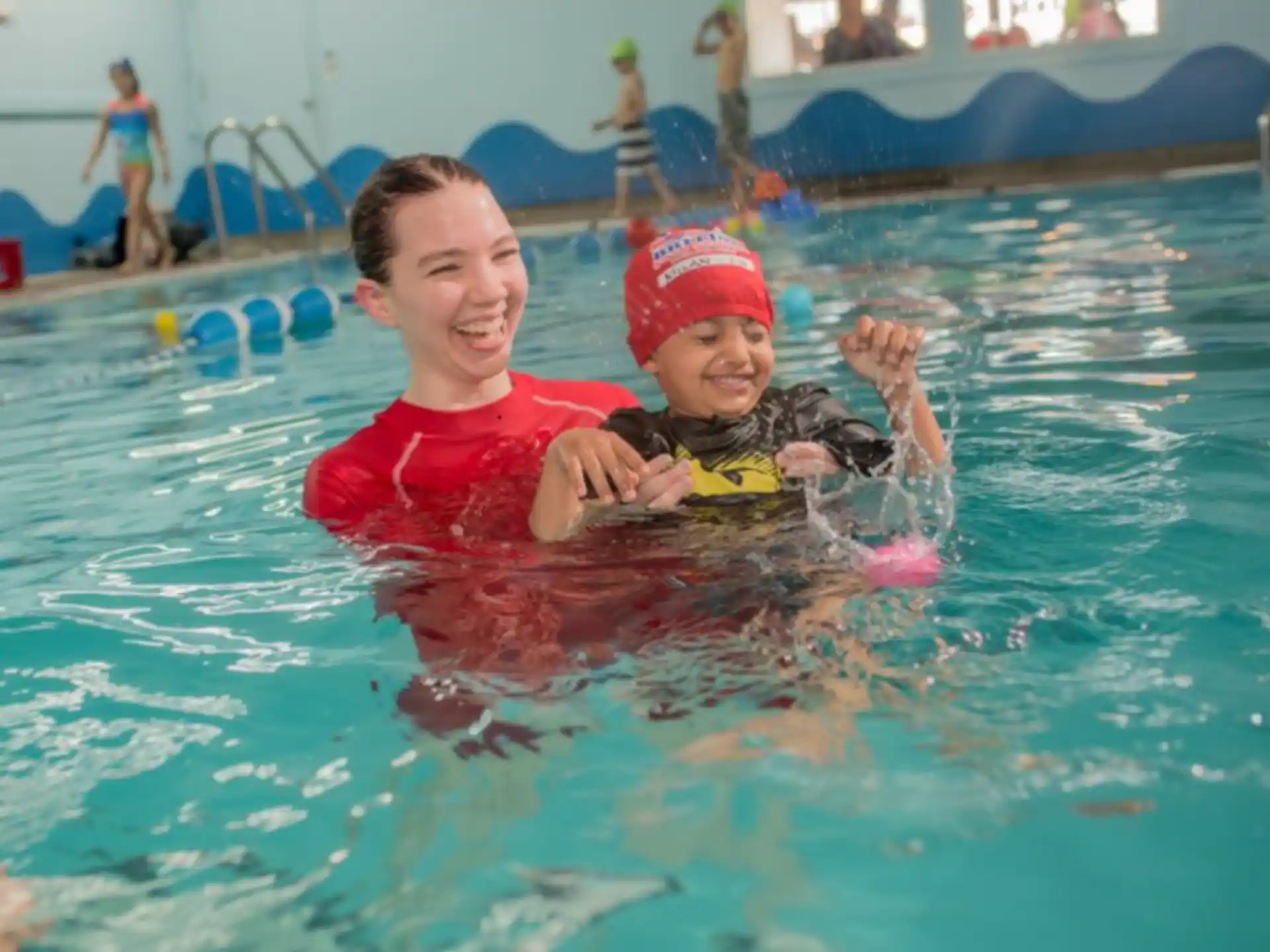 a person and a child in a pool