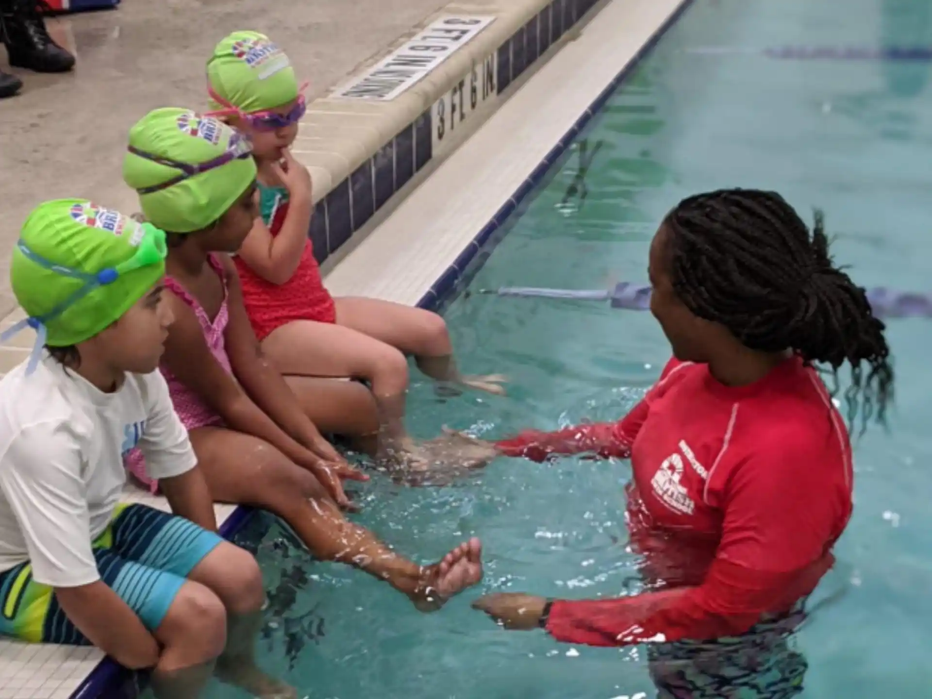 a group of kids playing in a pool