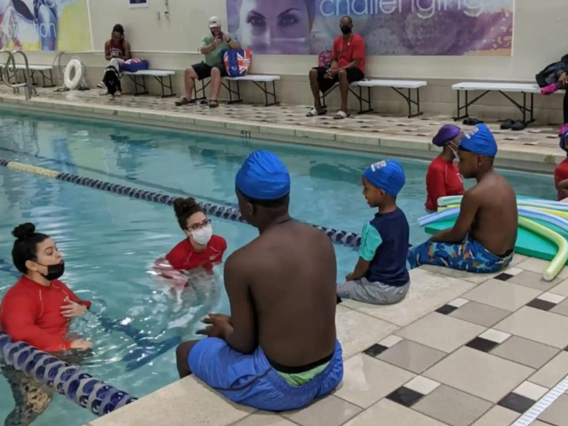 a group of people sitting in a pool