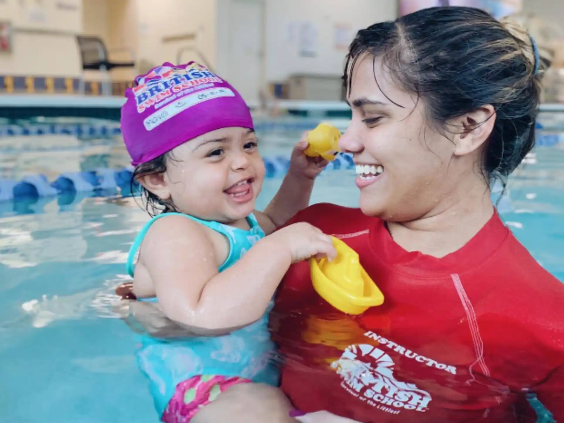 a person and a baby in a pool