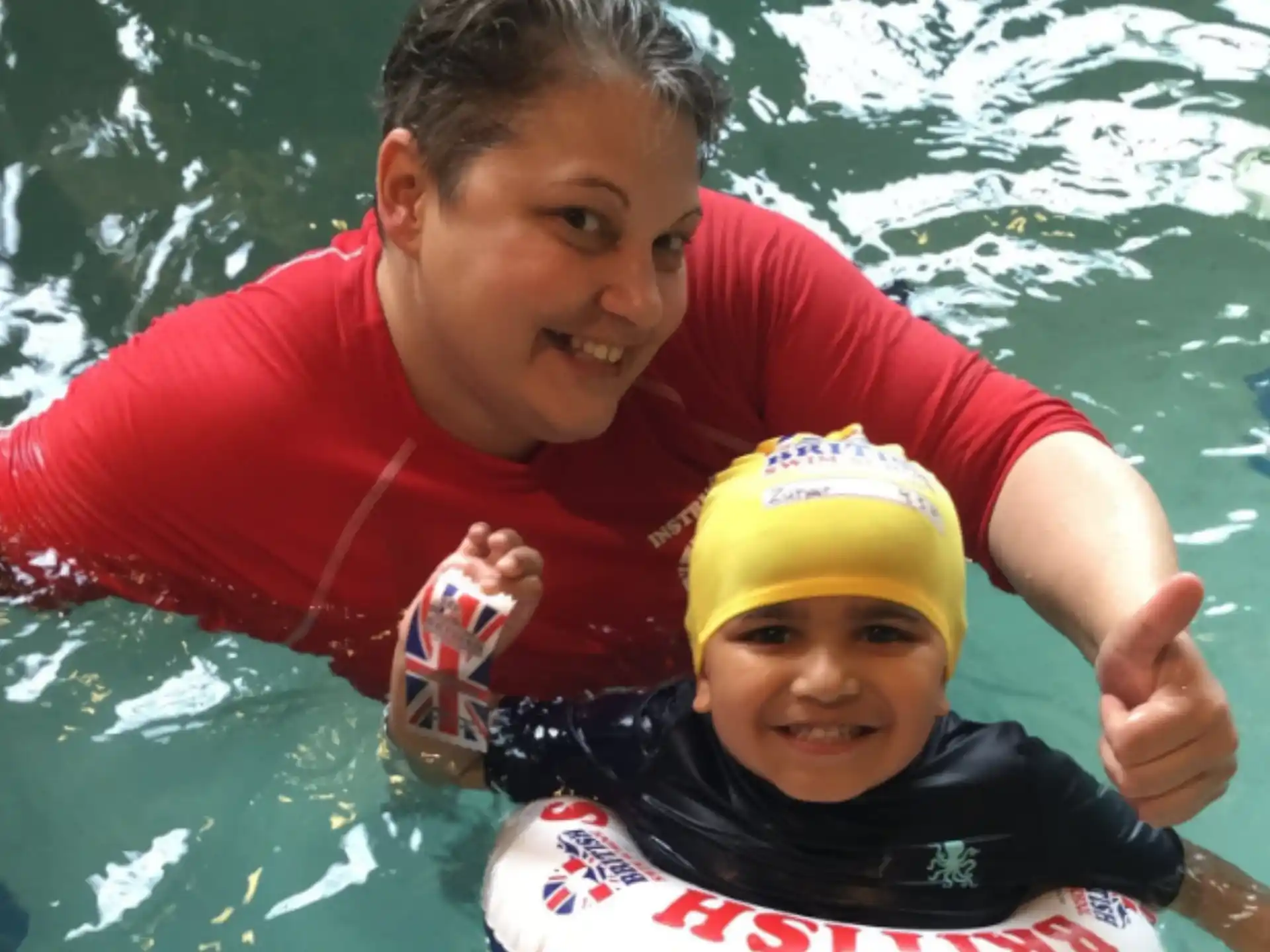 a person and a child in a pool