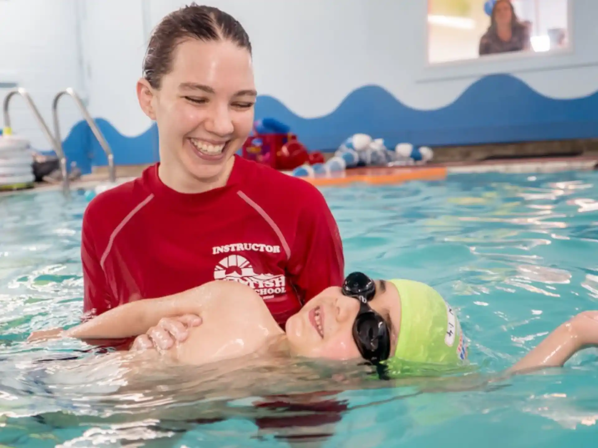 a person and a baby in a pool