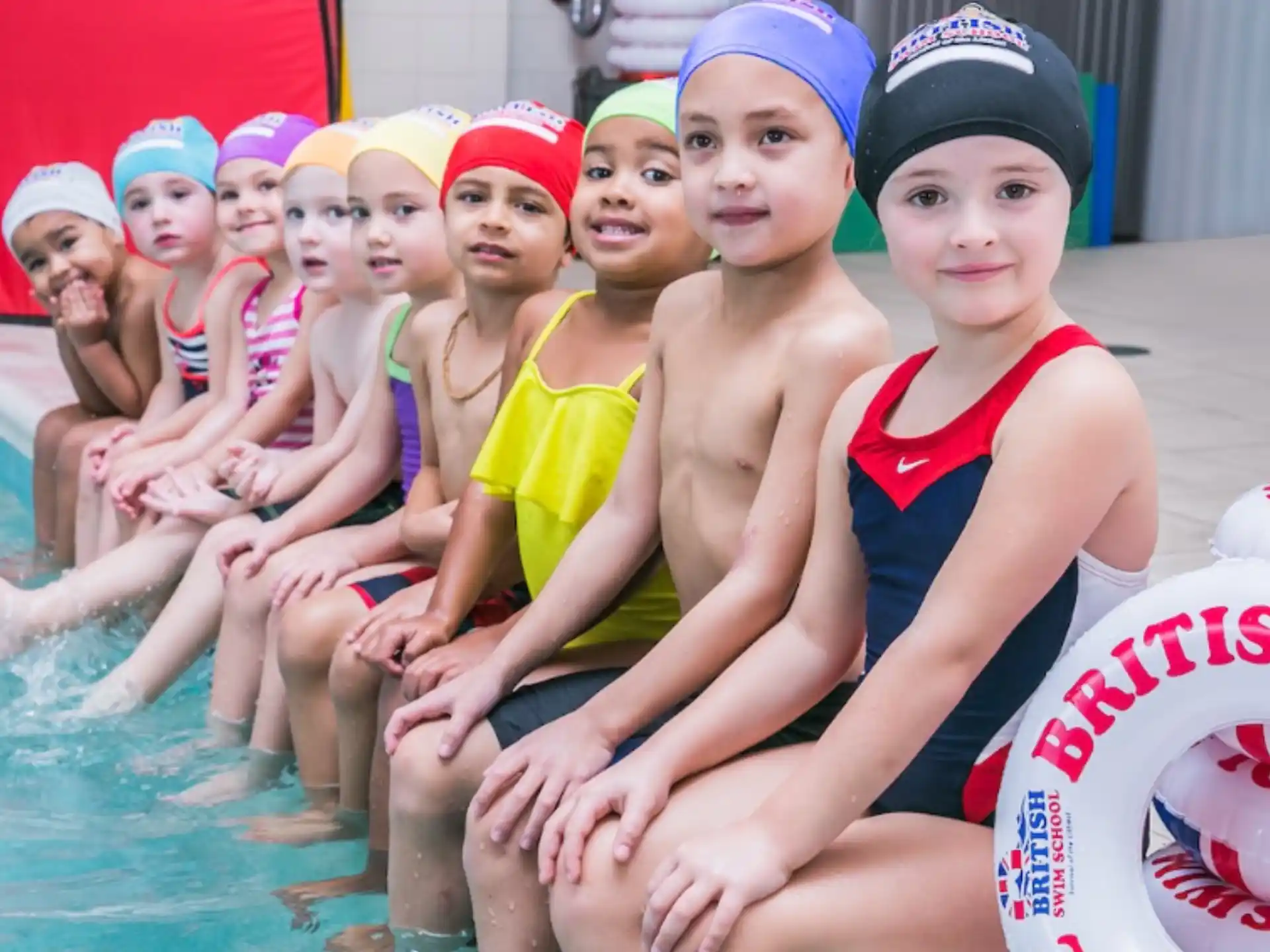 a group of people in swimsuits in a pool