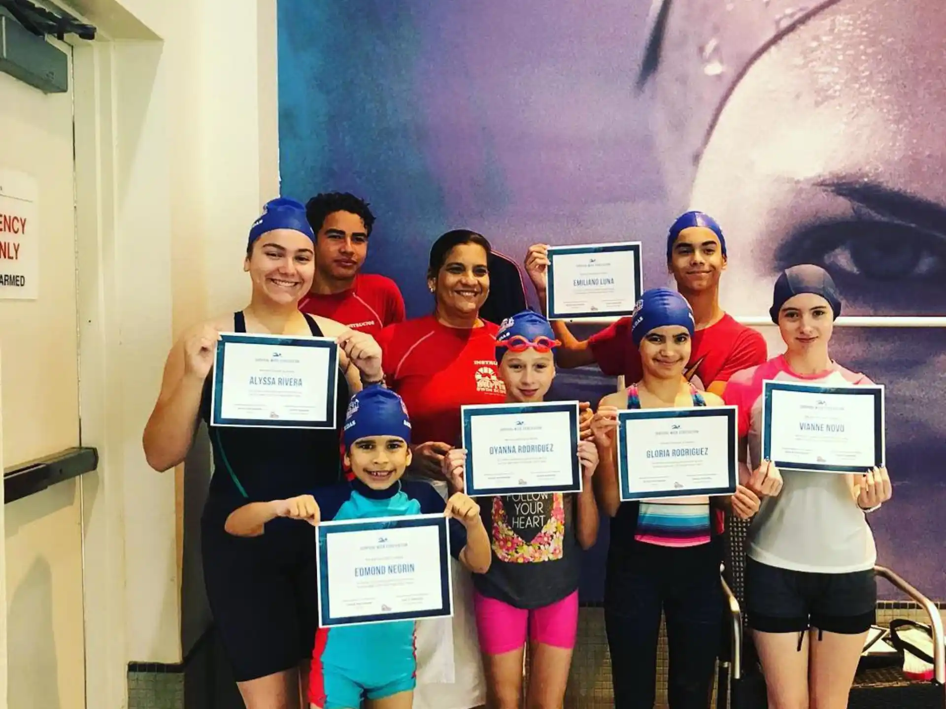 a group of people holding certificates