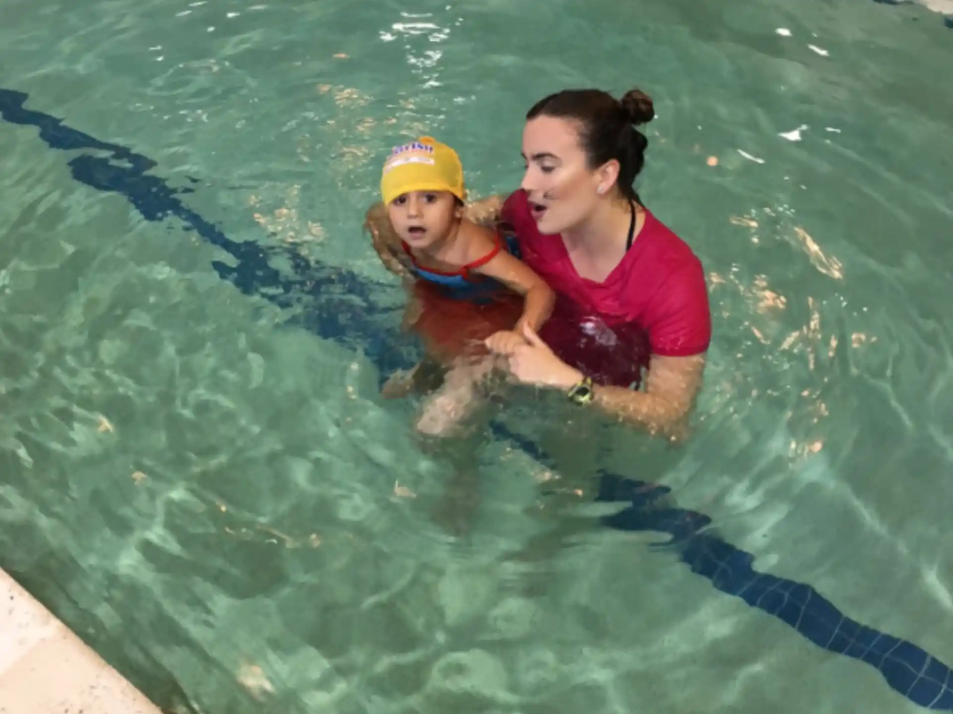 a person and a child in a pool