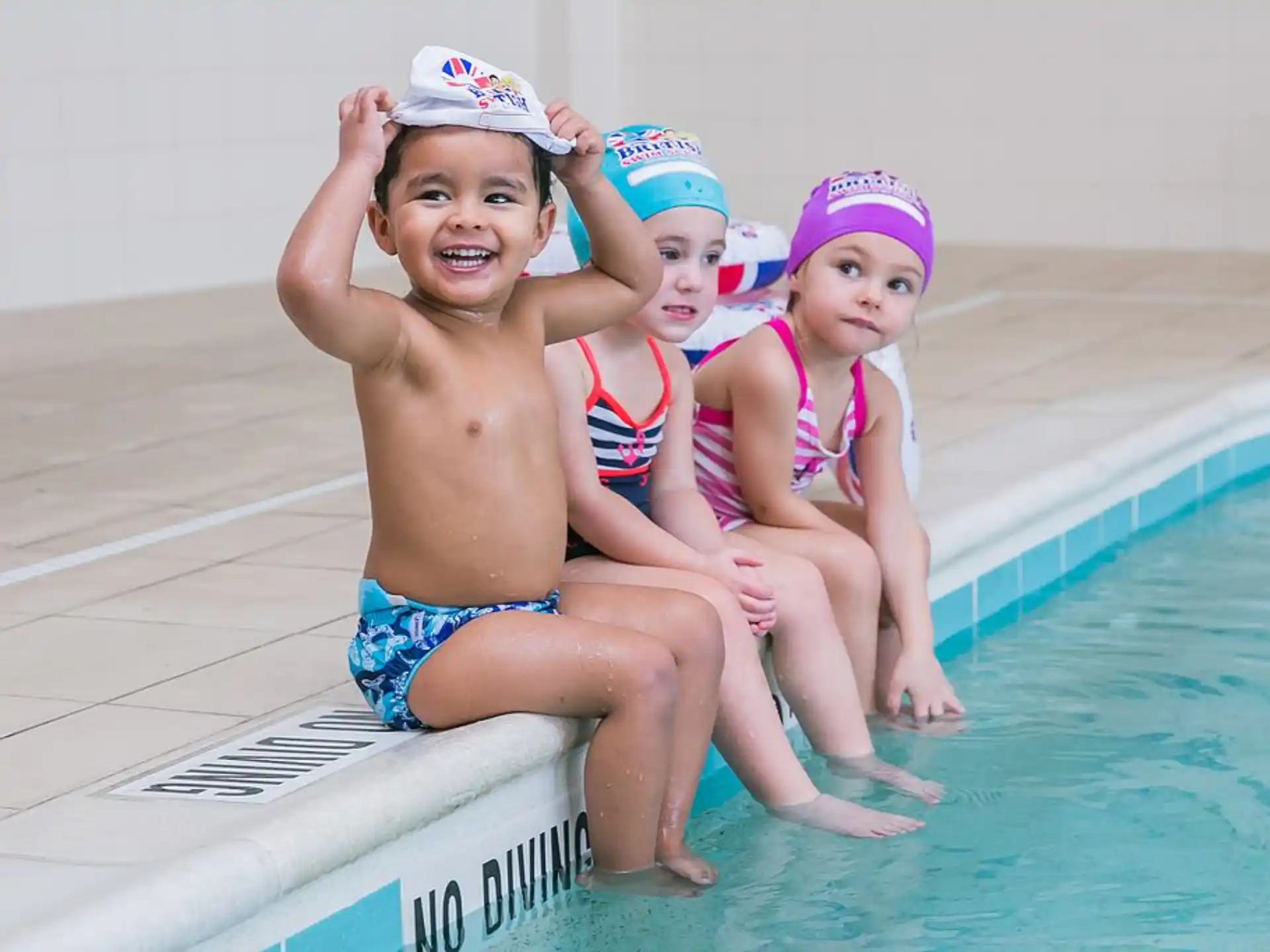 a person and two children in a pool