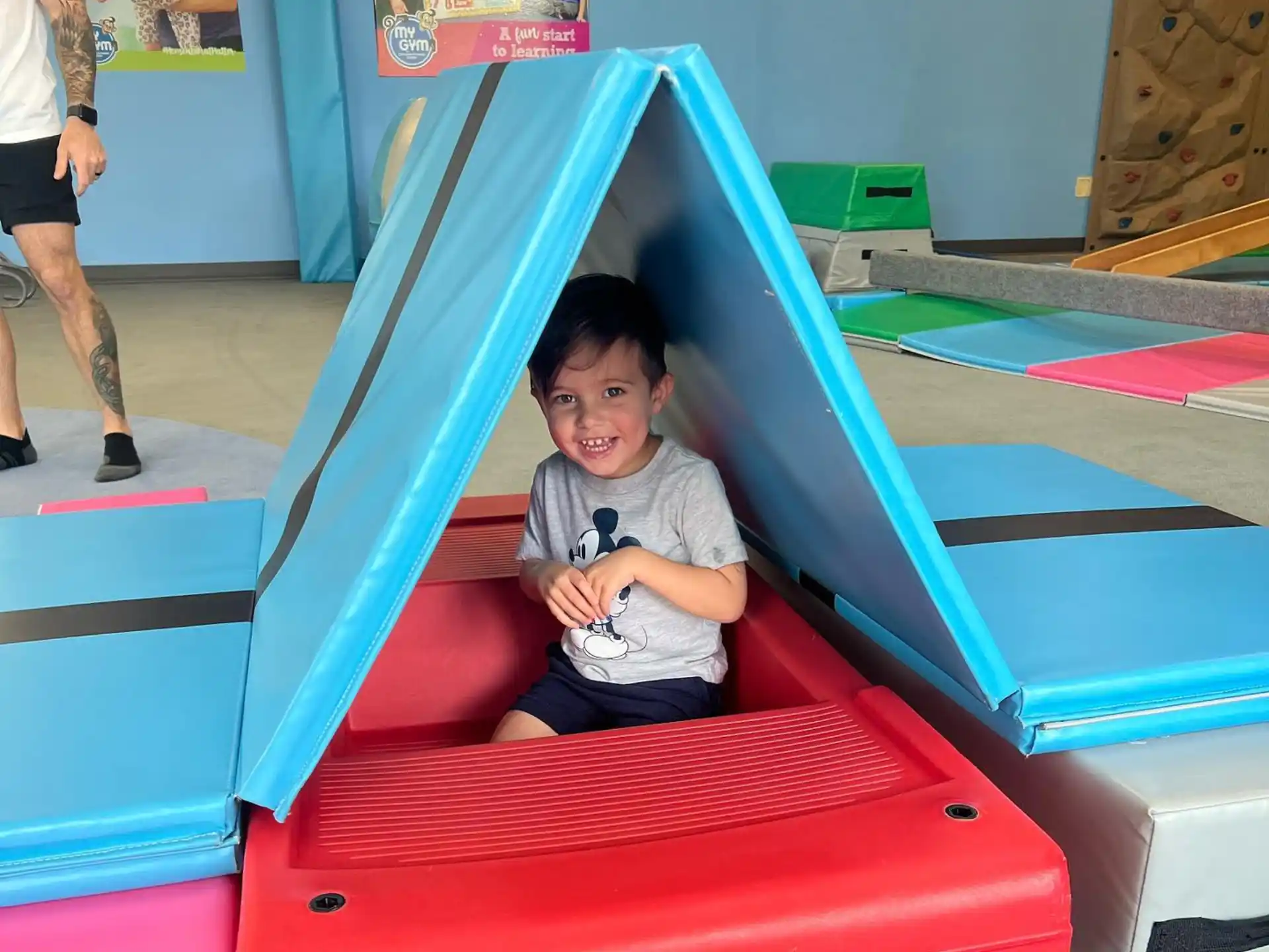 a child sitting on a red slide