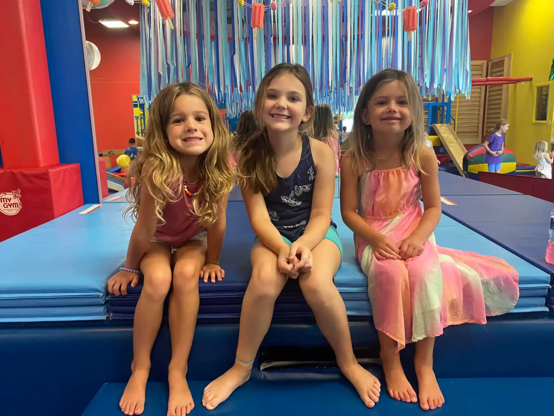 a group of girls sitting on a slide