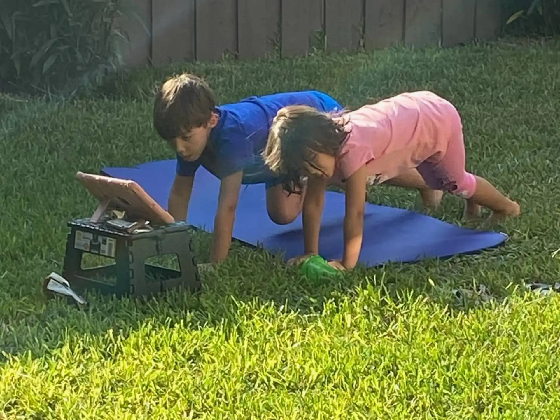 a man and a woman lying on a blanket in the grass