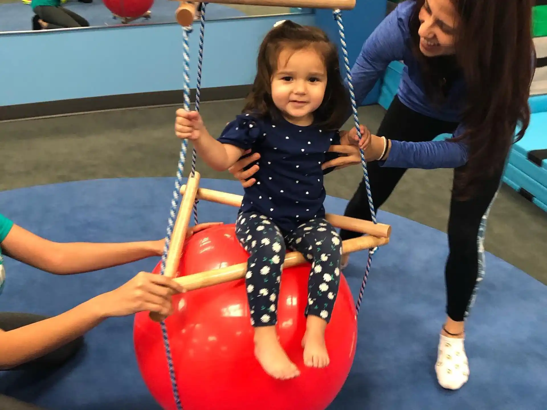 a person and a child on a playground toy