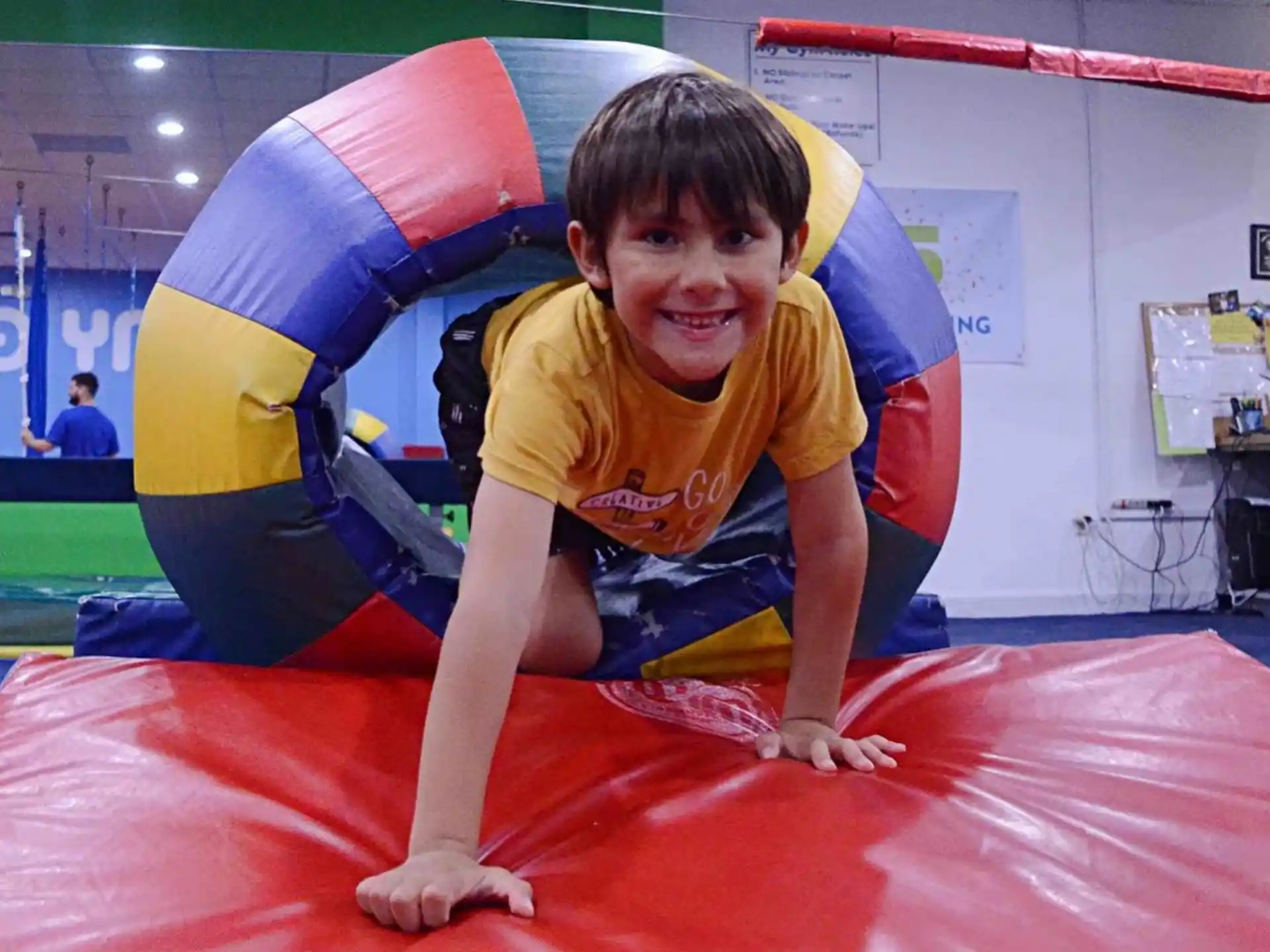 a boy in a yellow shirt