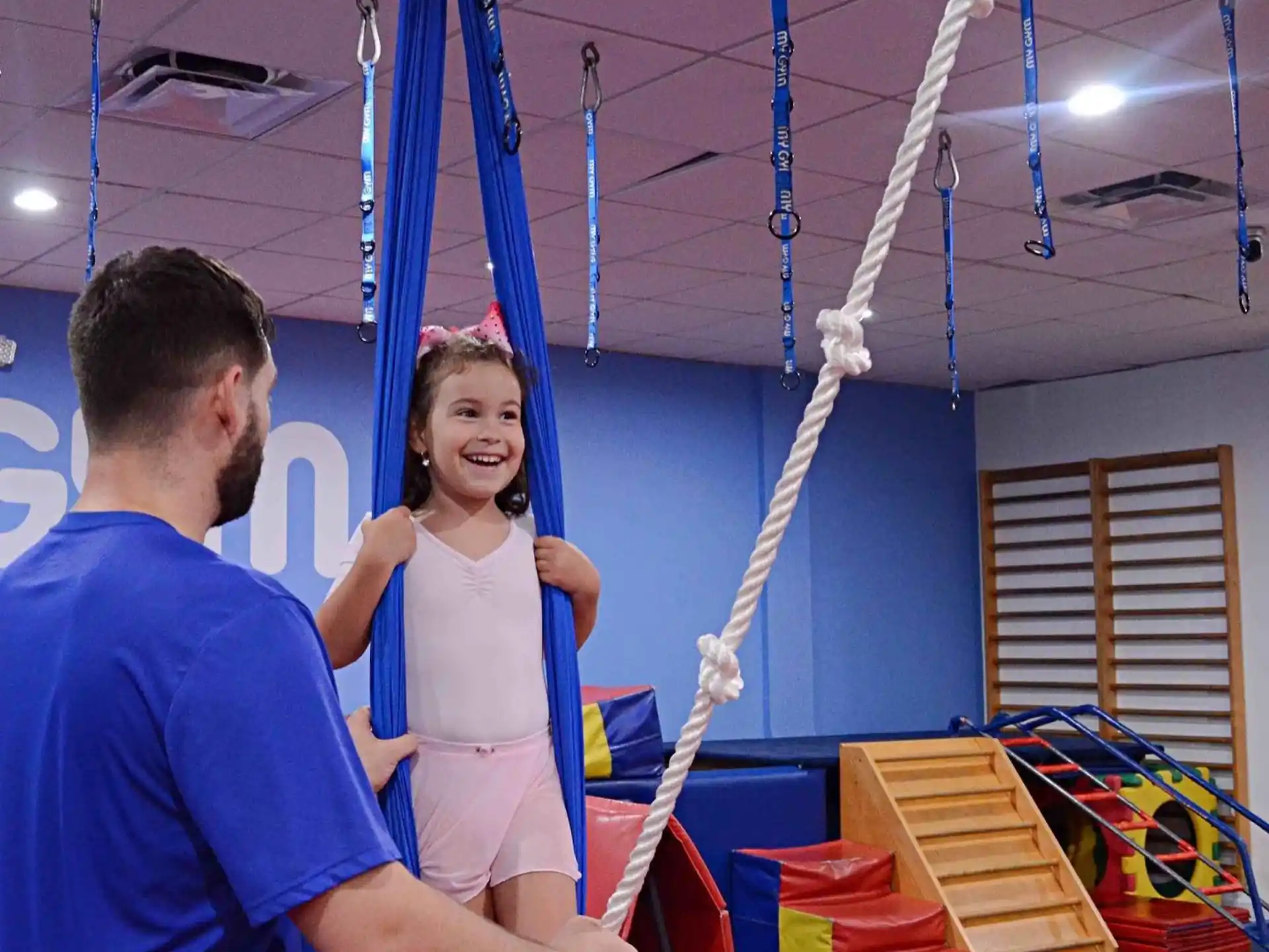 a man and a girl on a swing set