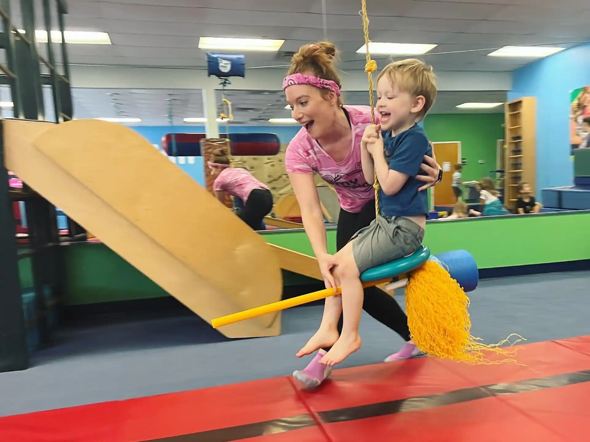 a girl and a boy on a swing