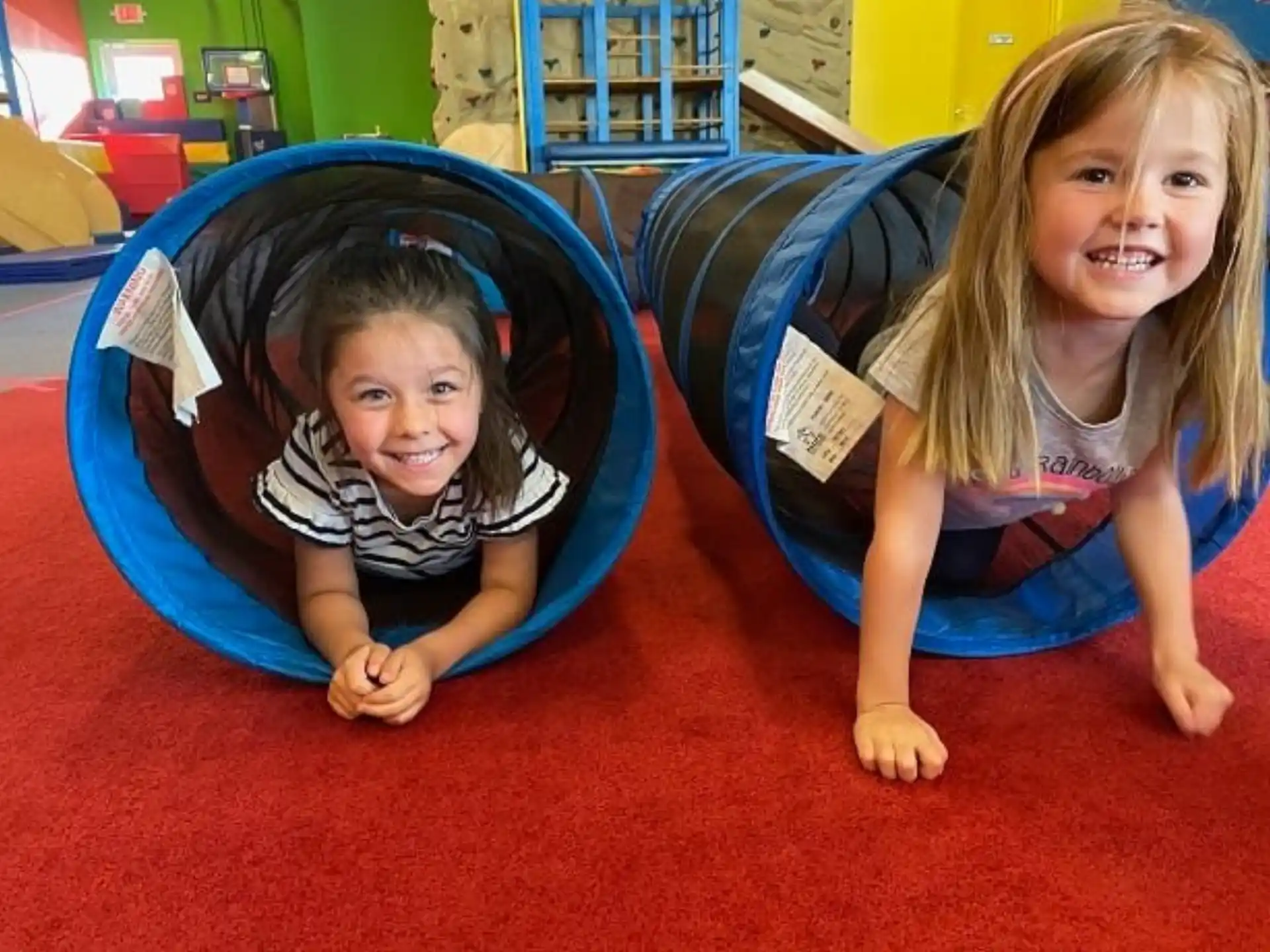 a couple of girls in a play room